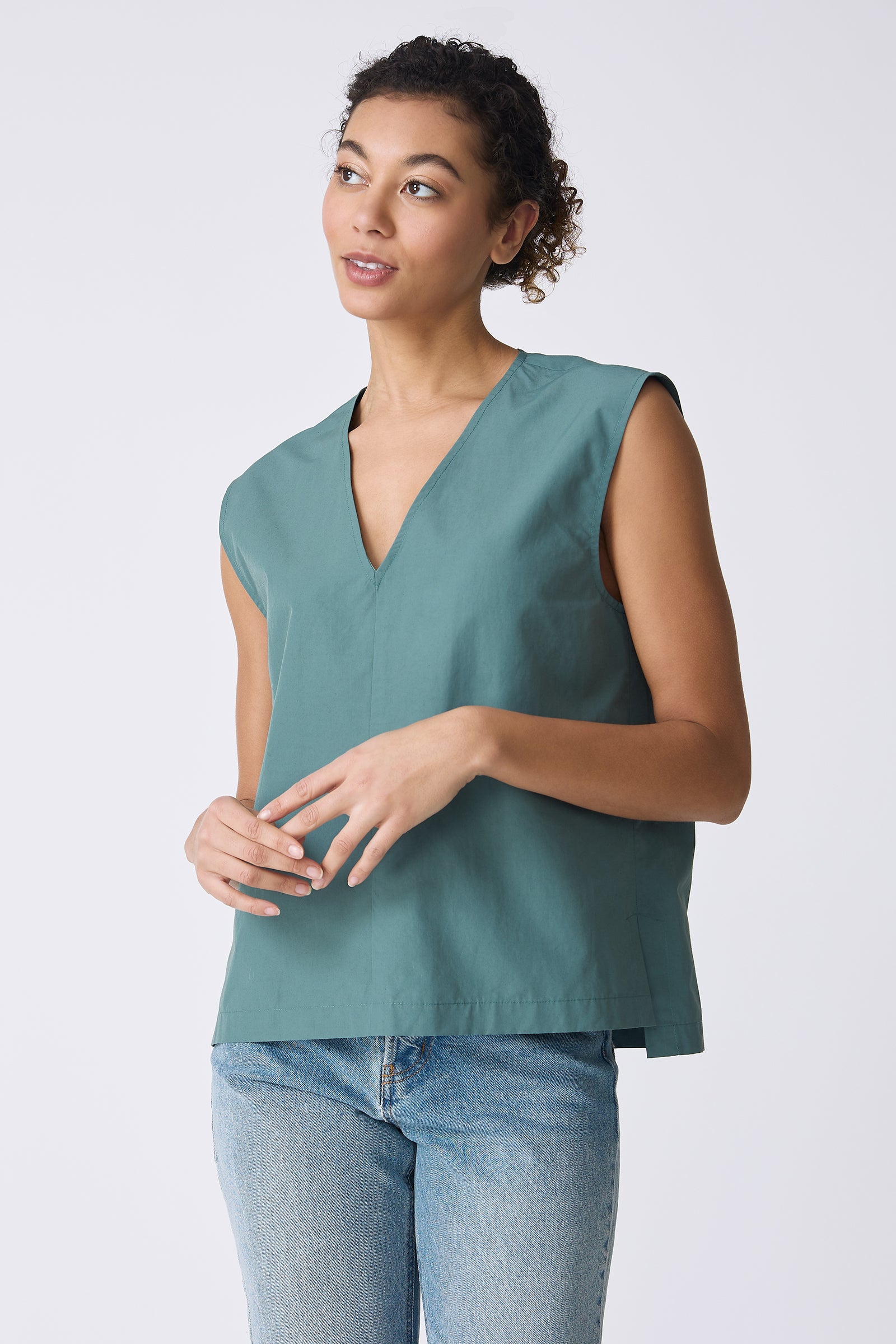 Ava V-Neck Shell Top in Sage on model looking right front view