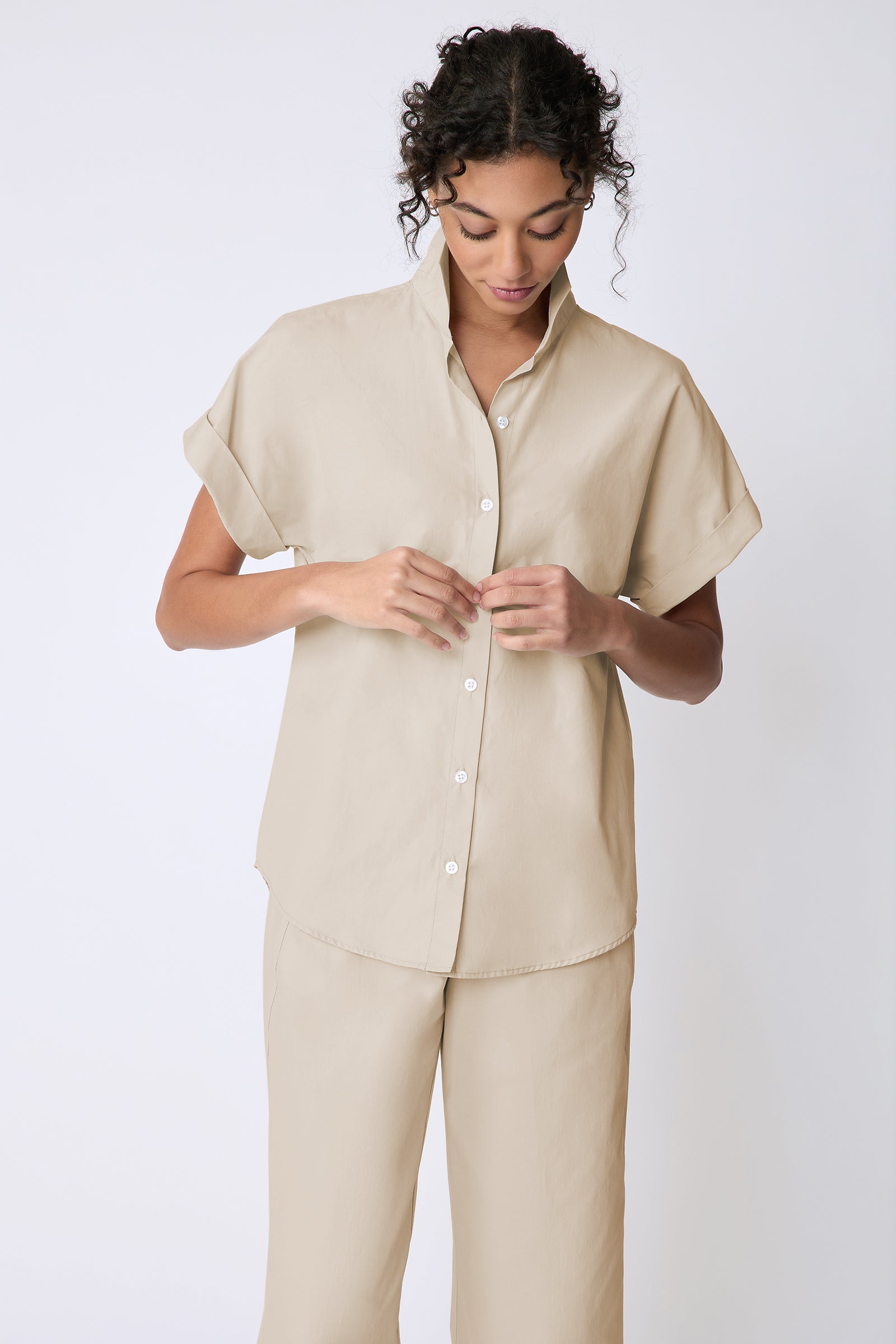 Kal Rieman Ali Kimono Top in Italian broadcloth color sand on model front view holding placket
