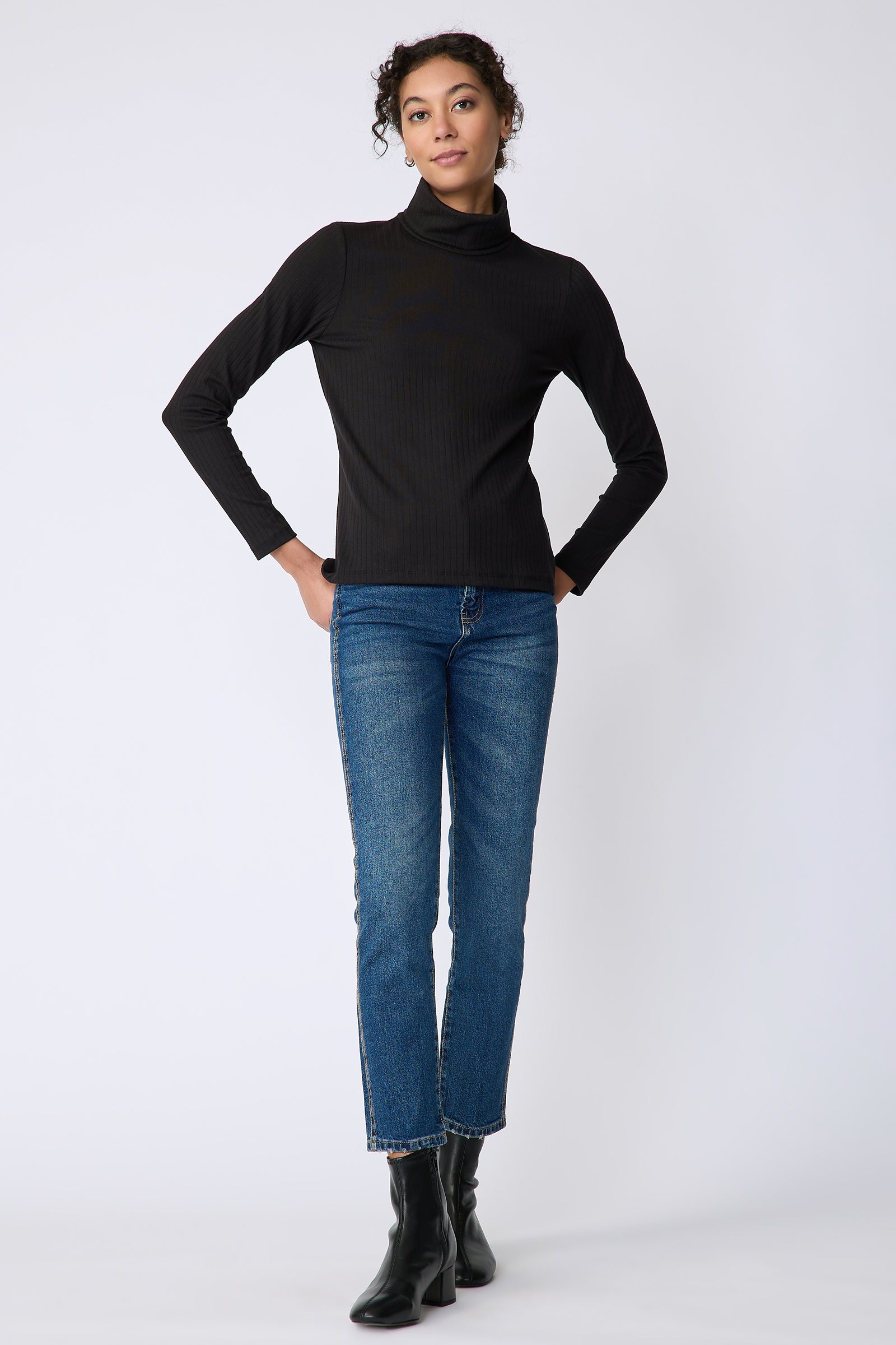 Kal Rieman Alma Rib knit tneck in black on front view full length hands in back pockets