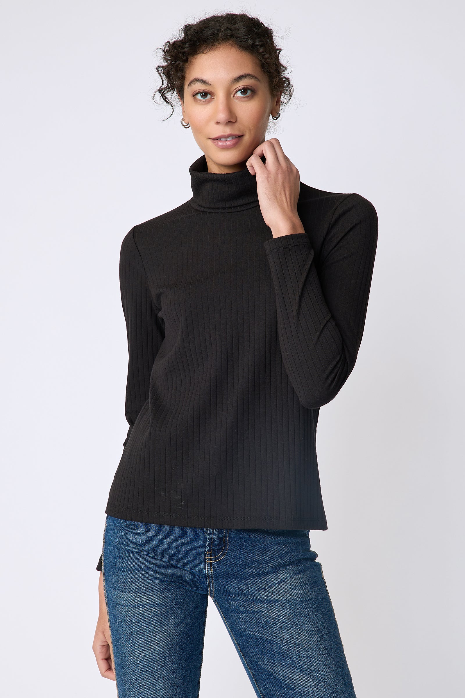 Kal Rieman Alma Rib knit tneck in black on front view holding collar