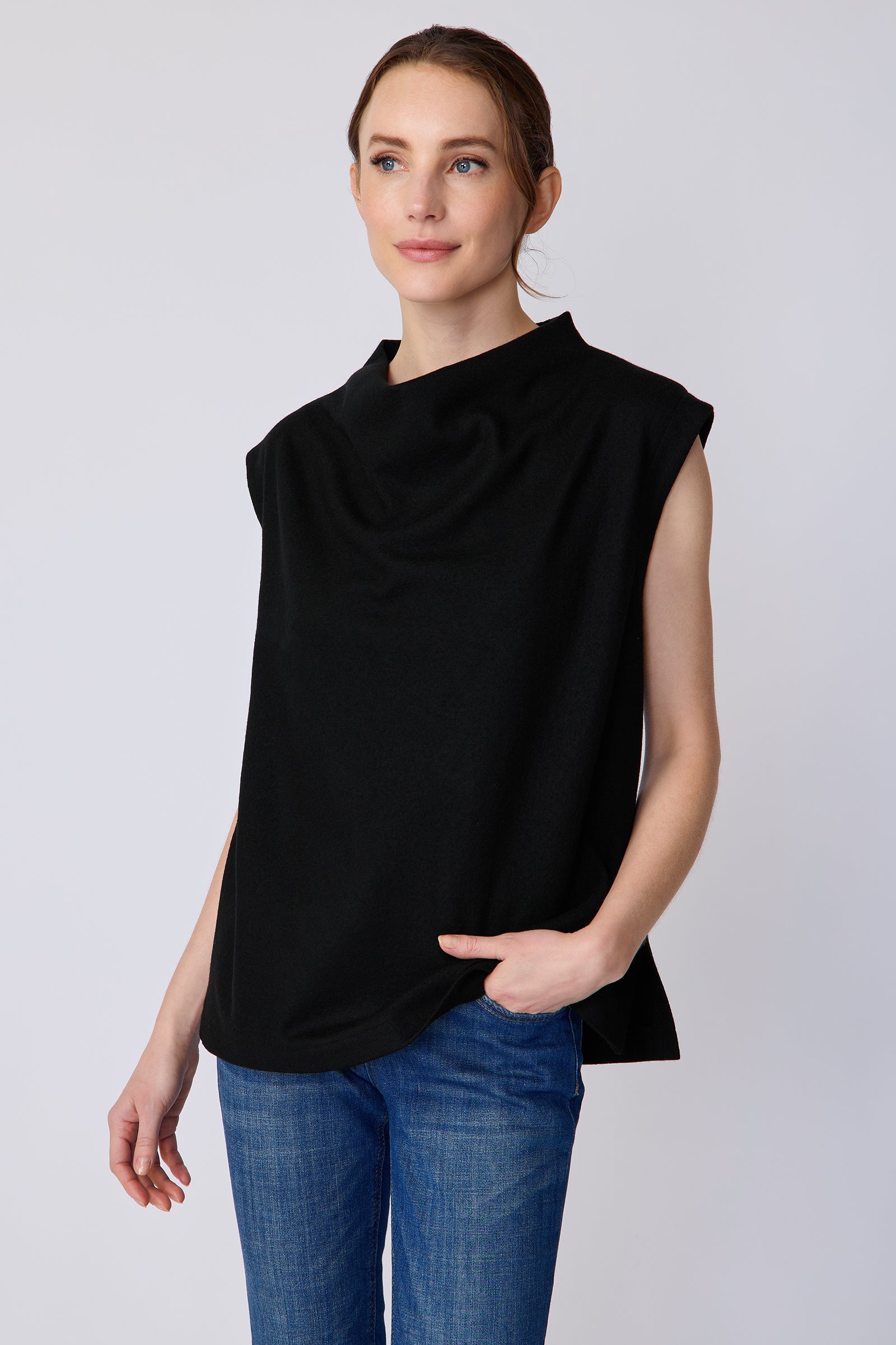 Woman wearing Kal Rieman Arla Drape Top in Black Felted Jersey with blue jeans, arm on the side, hand in pant pocket, looking sideways close view