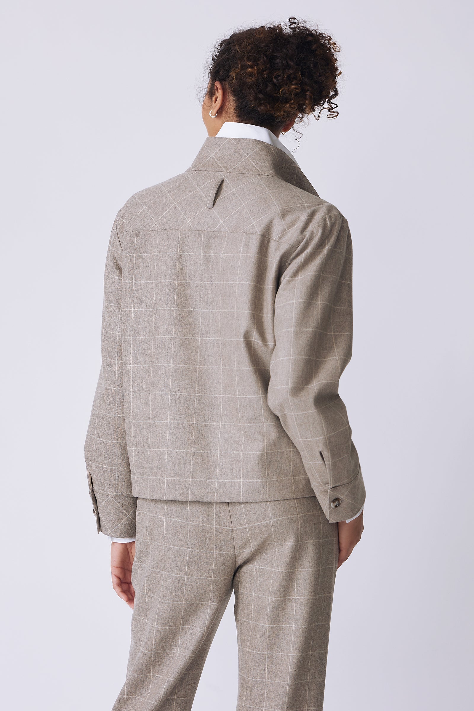 Kal Rieman Ashton Jacket in Italian Windowpane on model back view with hand in pant pocket