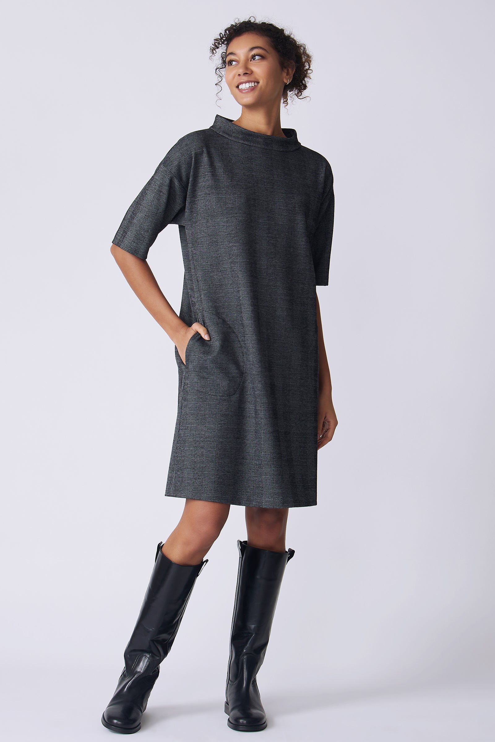 Kal Rieman Avery Dress in black plaid on model side view hand in pocket