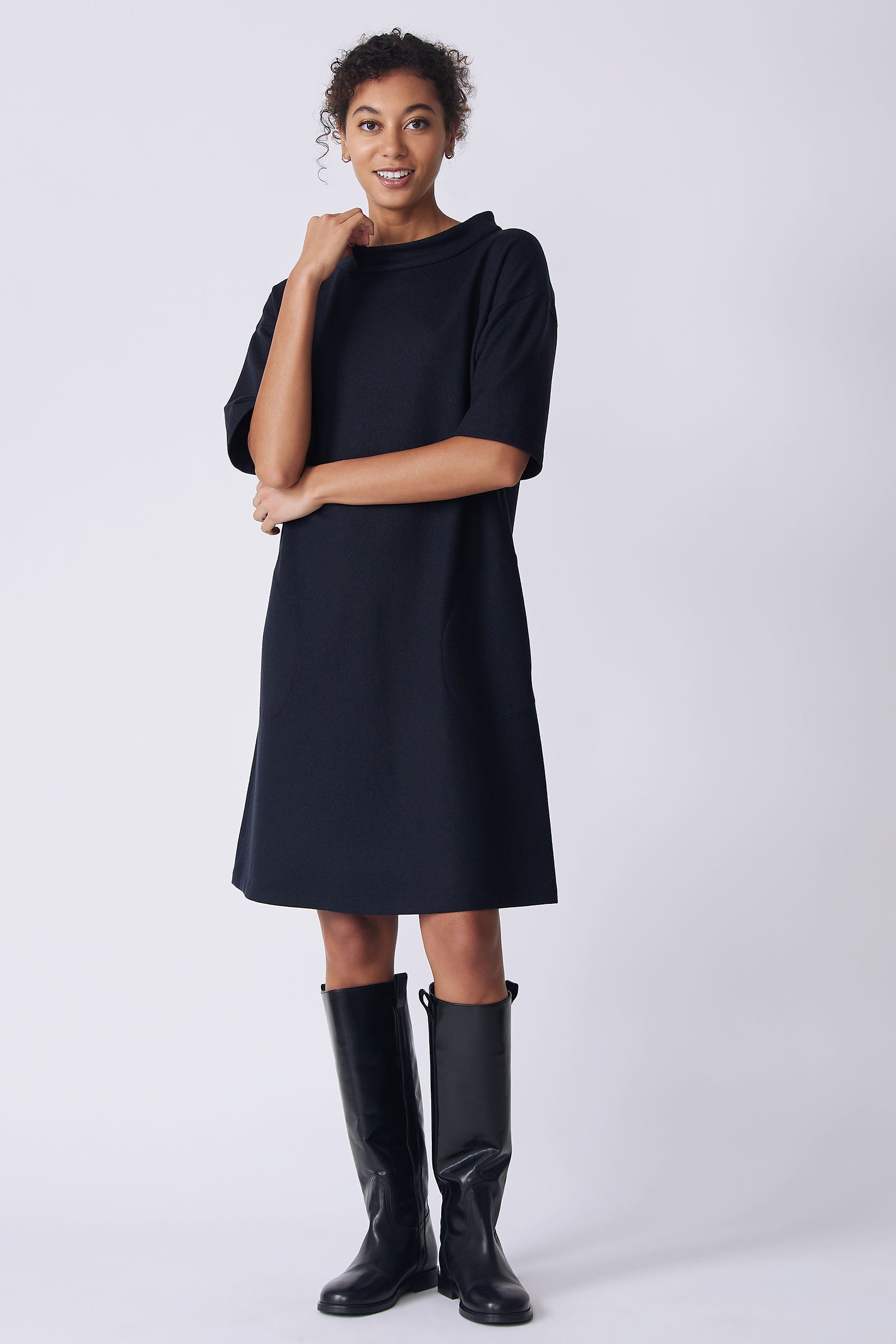 Kal Rieman Avery Dress in midnight felted jersey on model front view holding collar