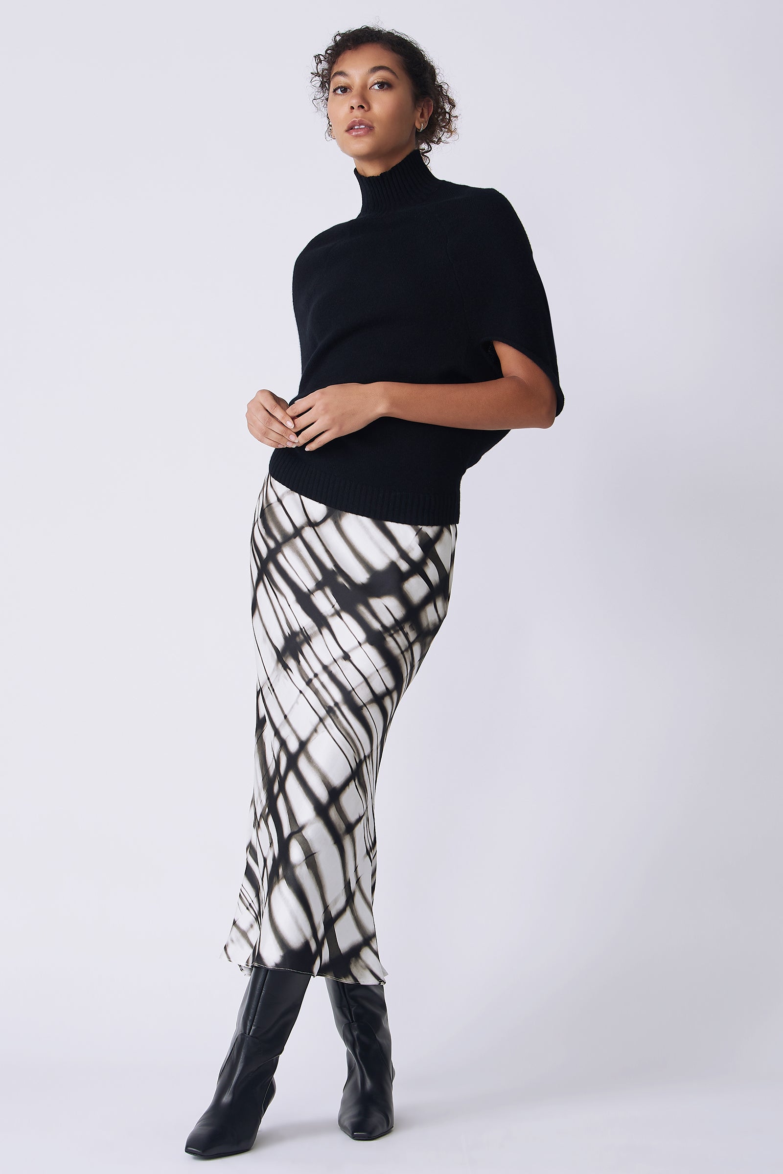 Kal Rieman Bias silk skirt in watercolor print on model front view holding hands