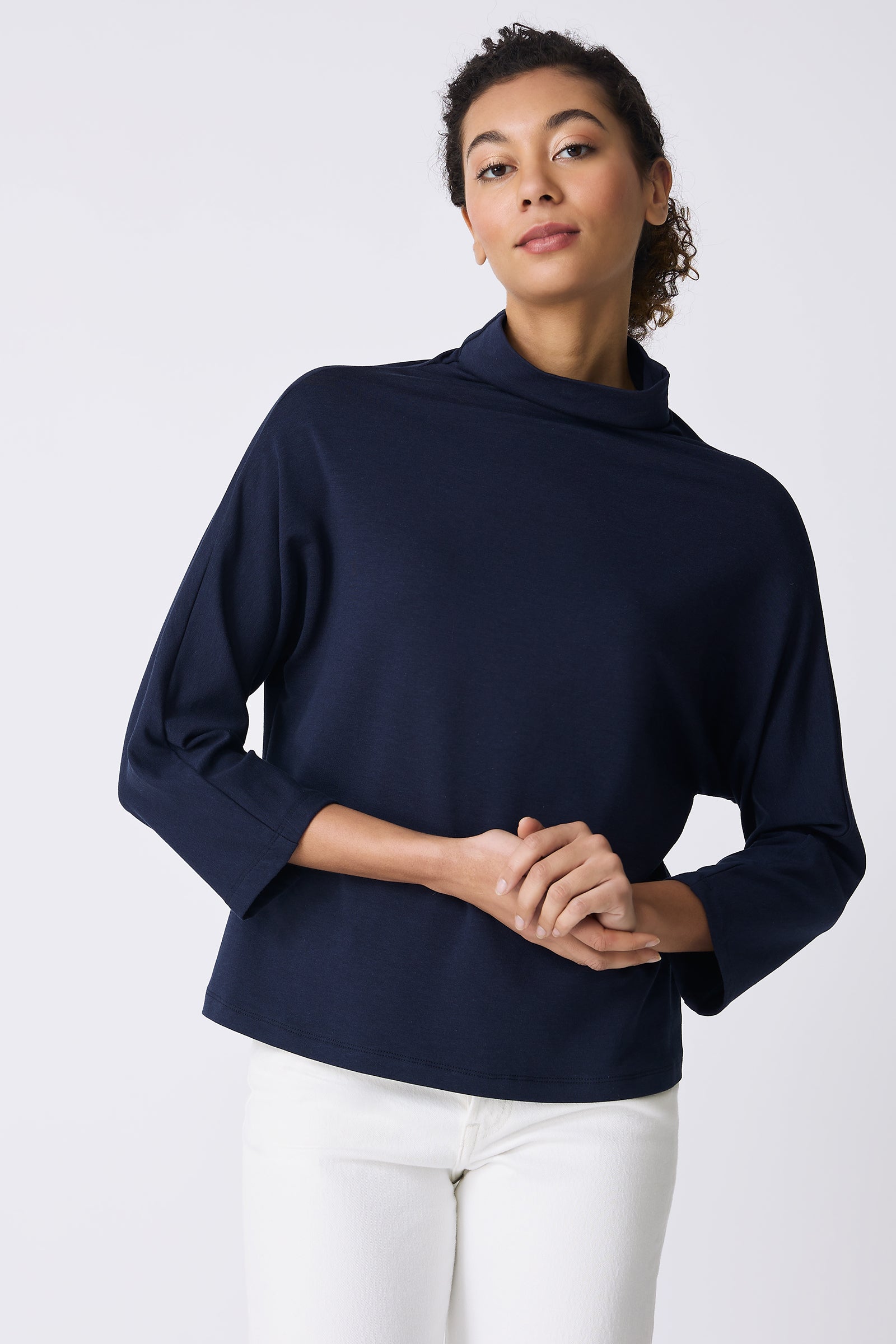 Kal Rieman Brigitte Mock Funnel in Navy on model holding hands front view