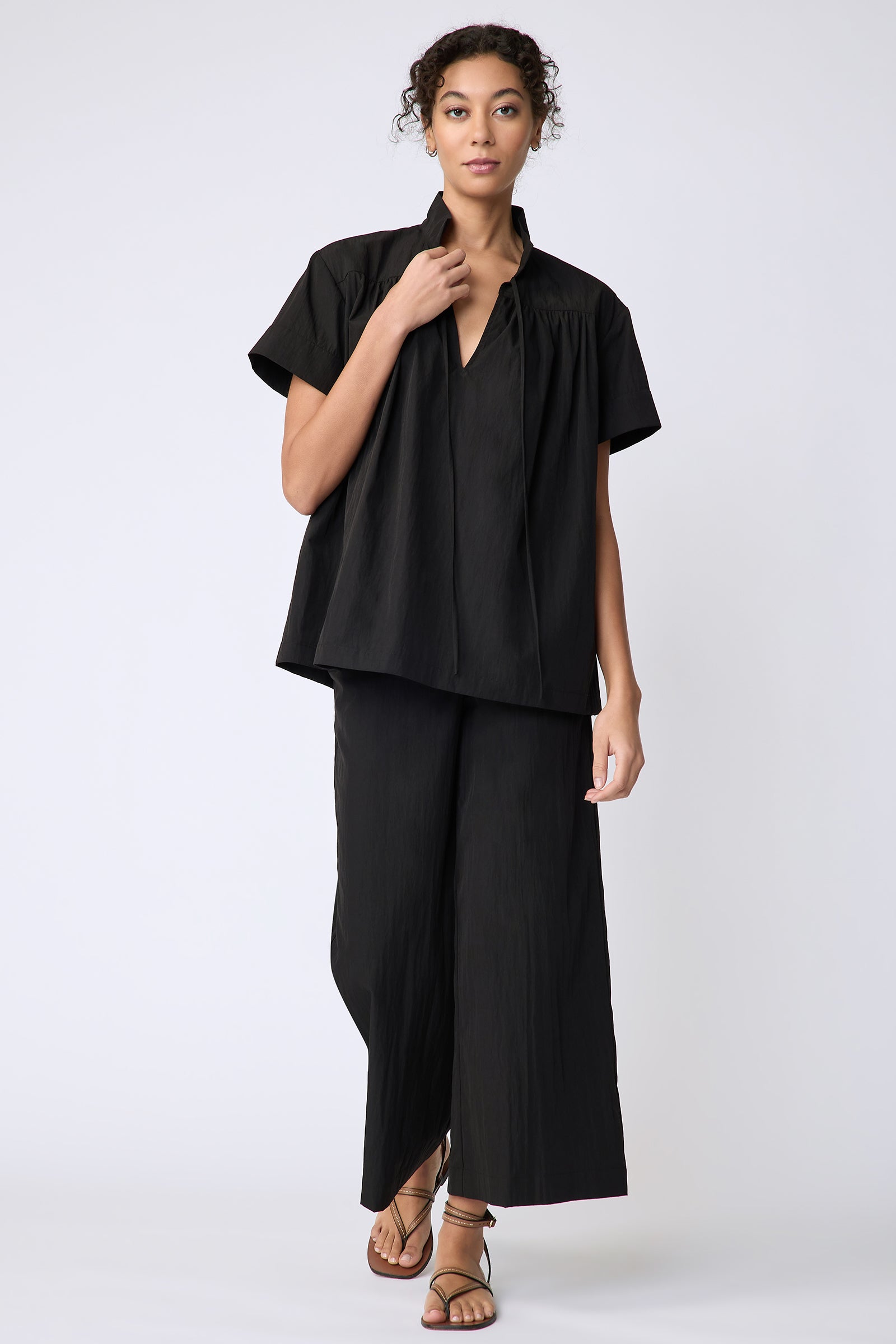 Kal Rieman Camille Top in black typewriter cloth on model front view walking holding collar