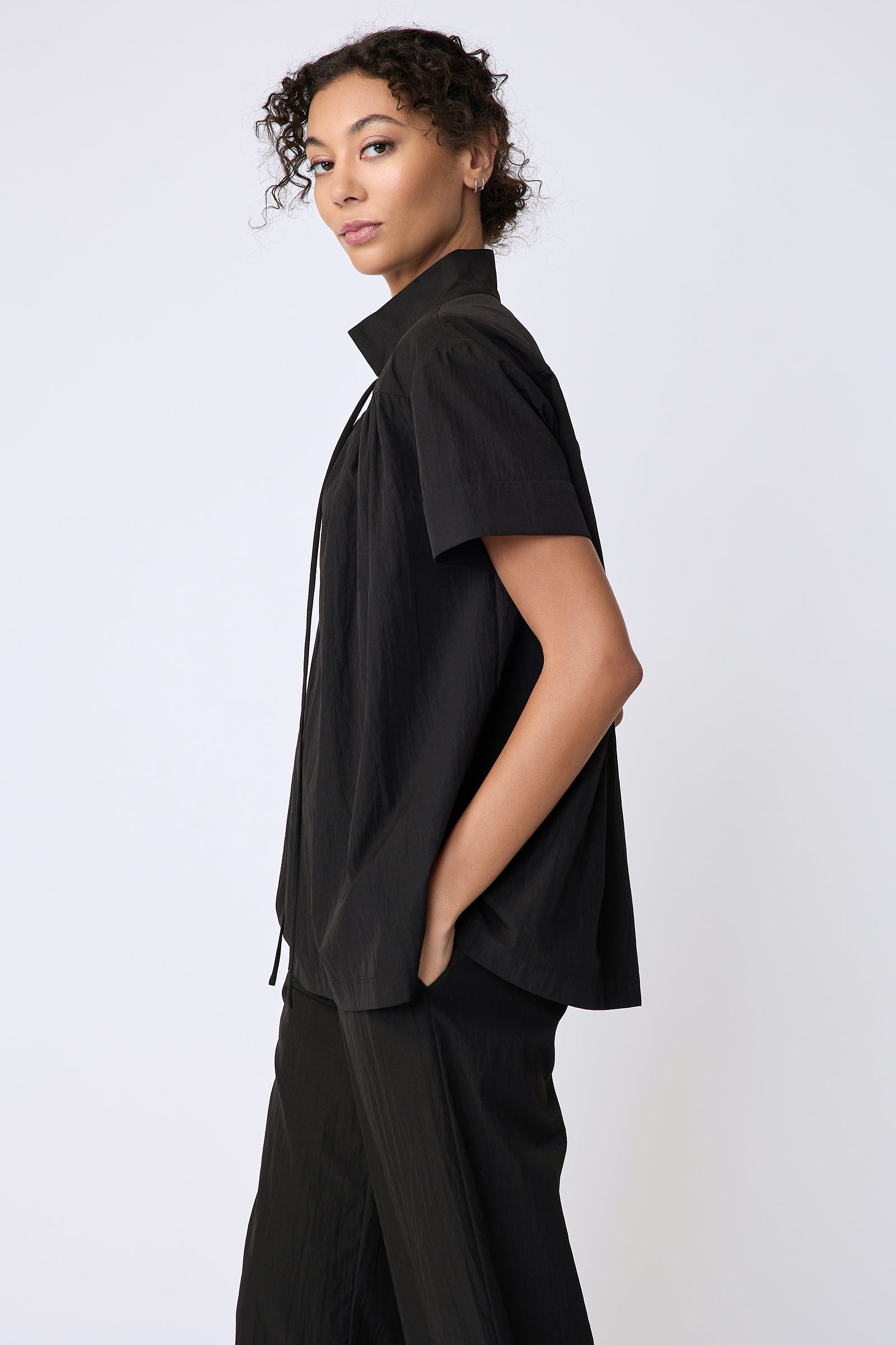 Kal Rieman Camille Top in black typewriter cloth on model side view hands in pockets