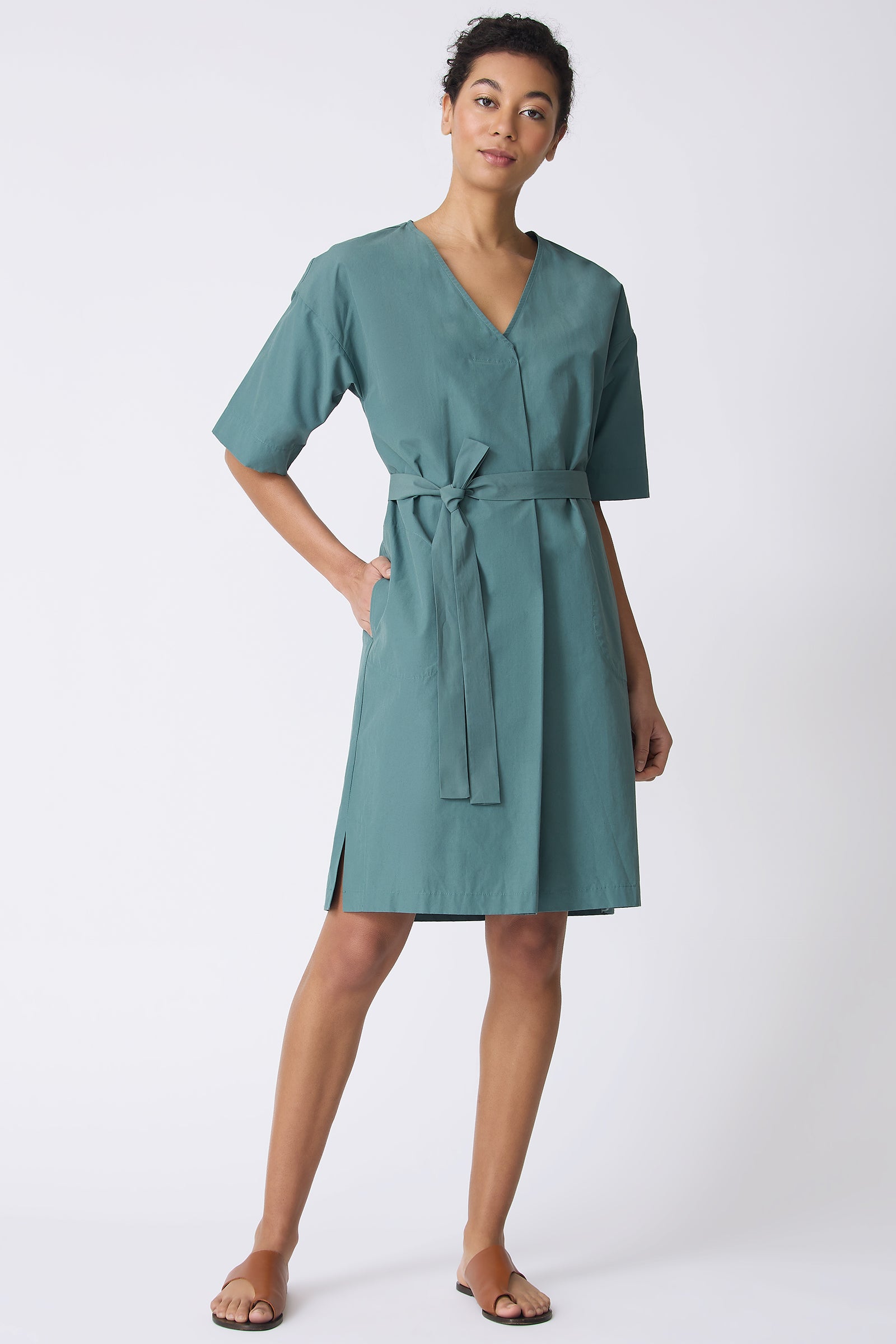 Kal Rieman Cara Fold Front Dress in Sage on model with hand in pocket full front view