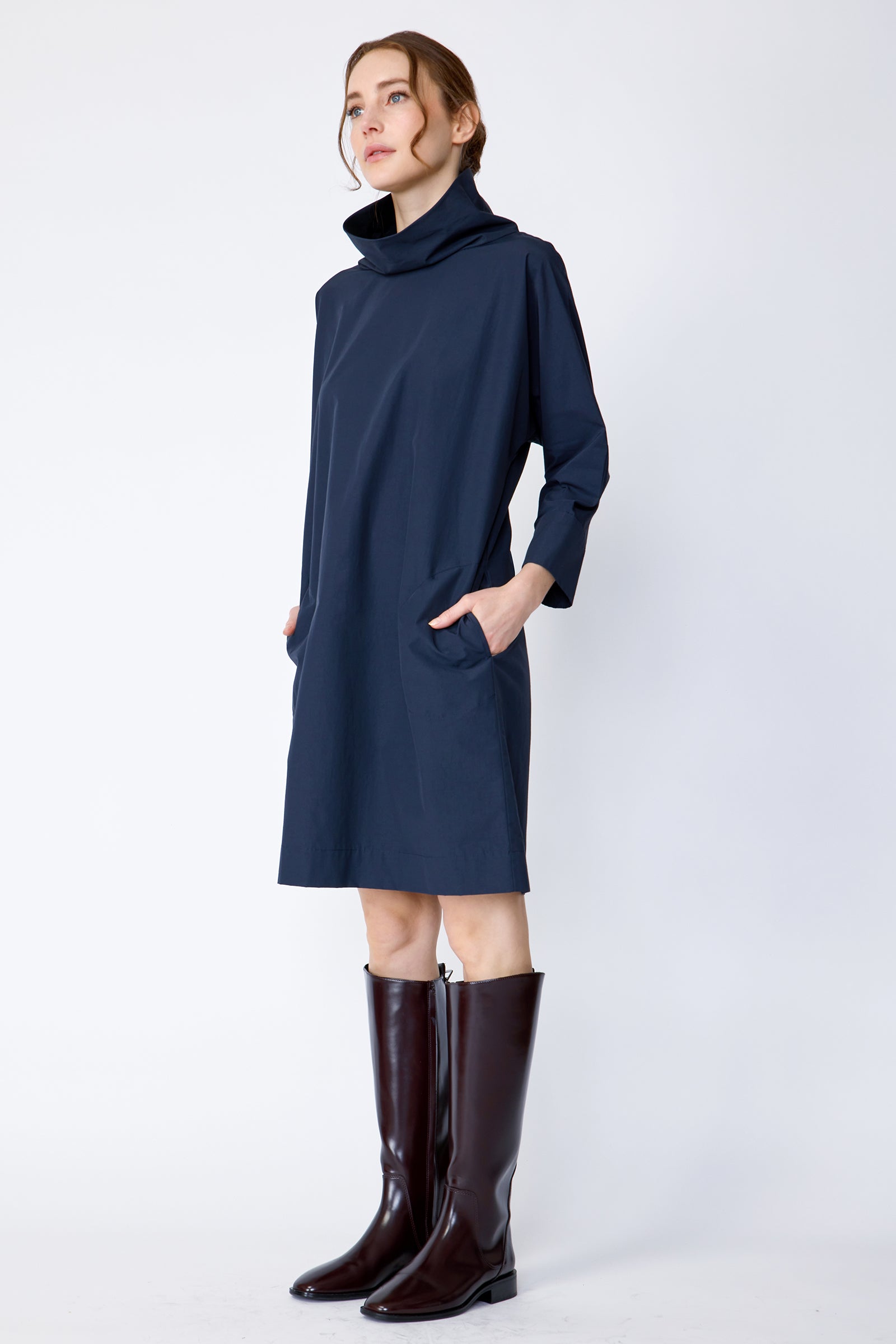 Kal Rieman Carla dress in navy Italian broadcloth on model side view hands in pockets