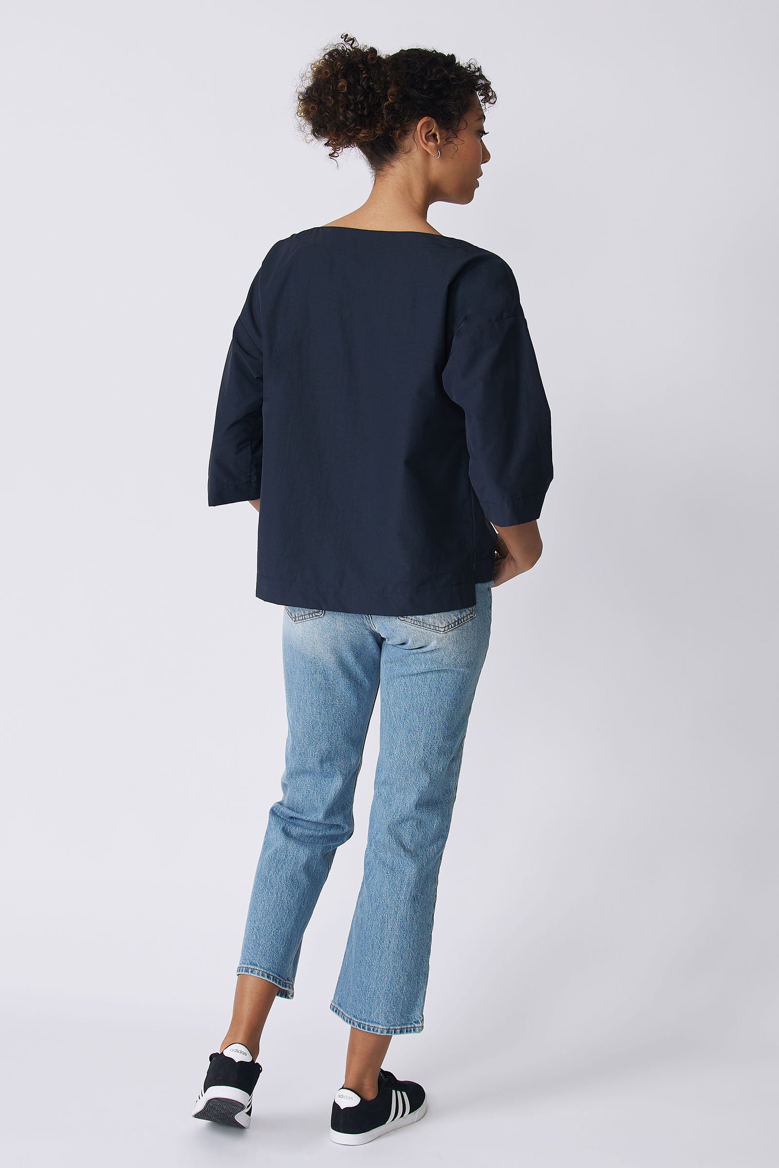 Kal Rieman Carmen Pocket Tee in Navy Broadcloth on model back view walking