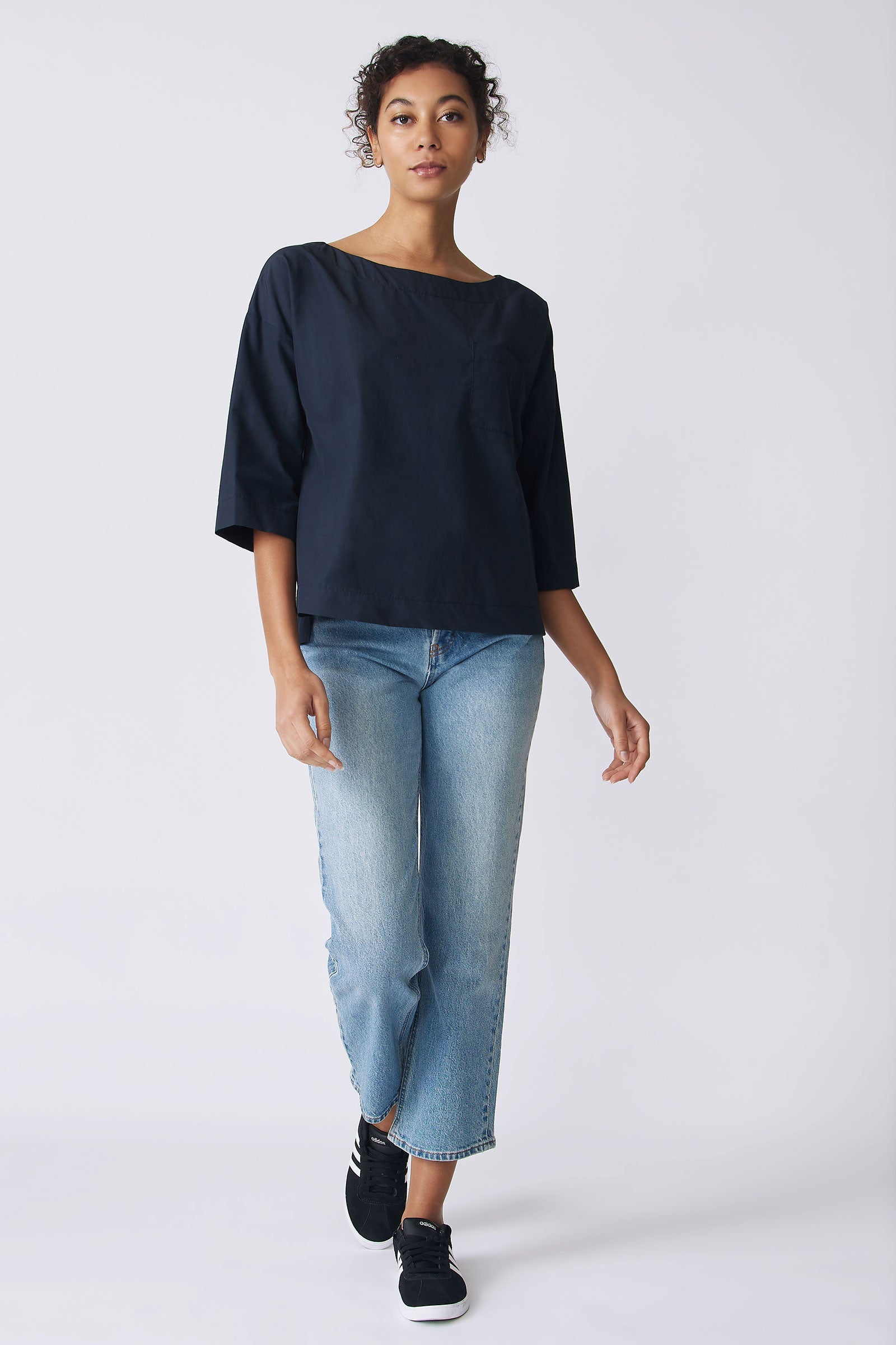 Kal Rieman Carmen Pocket Tee in Navy Broadcloth on model front view walking