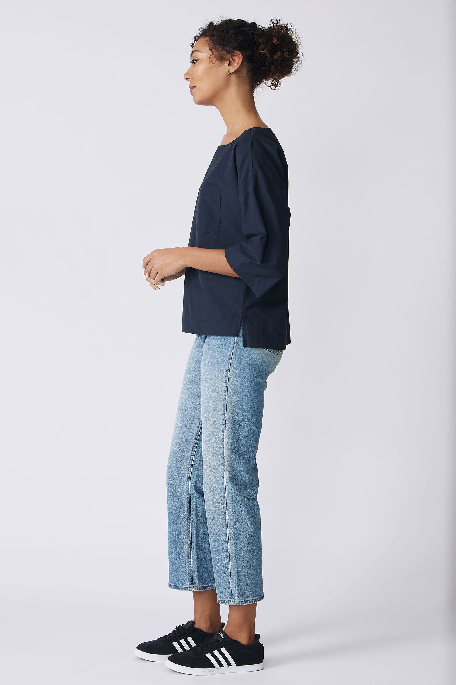 Kal Rieman Carmen Pocket Tee in Navy Broadcloth on model side view hands in front full look
