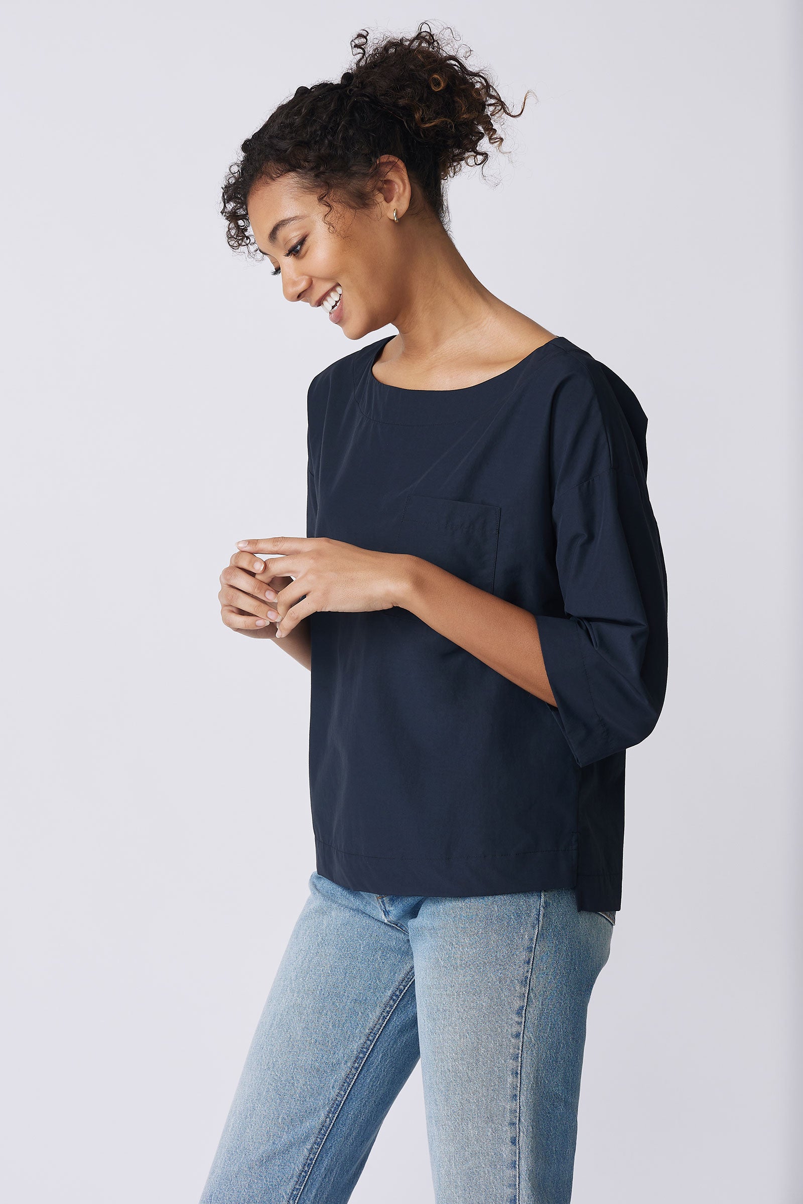Kal Rieman Carmen Pocket Tee in Navy Broadcloth on model side view hands in front