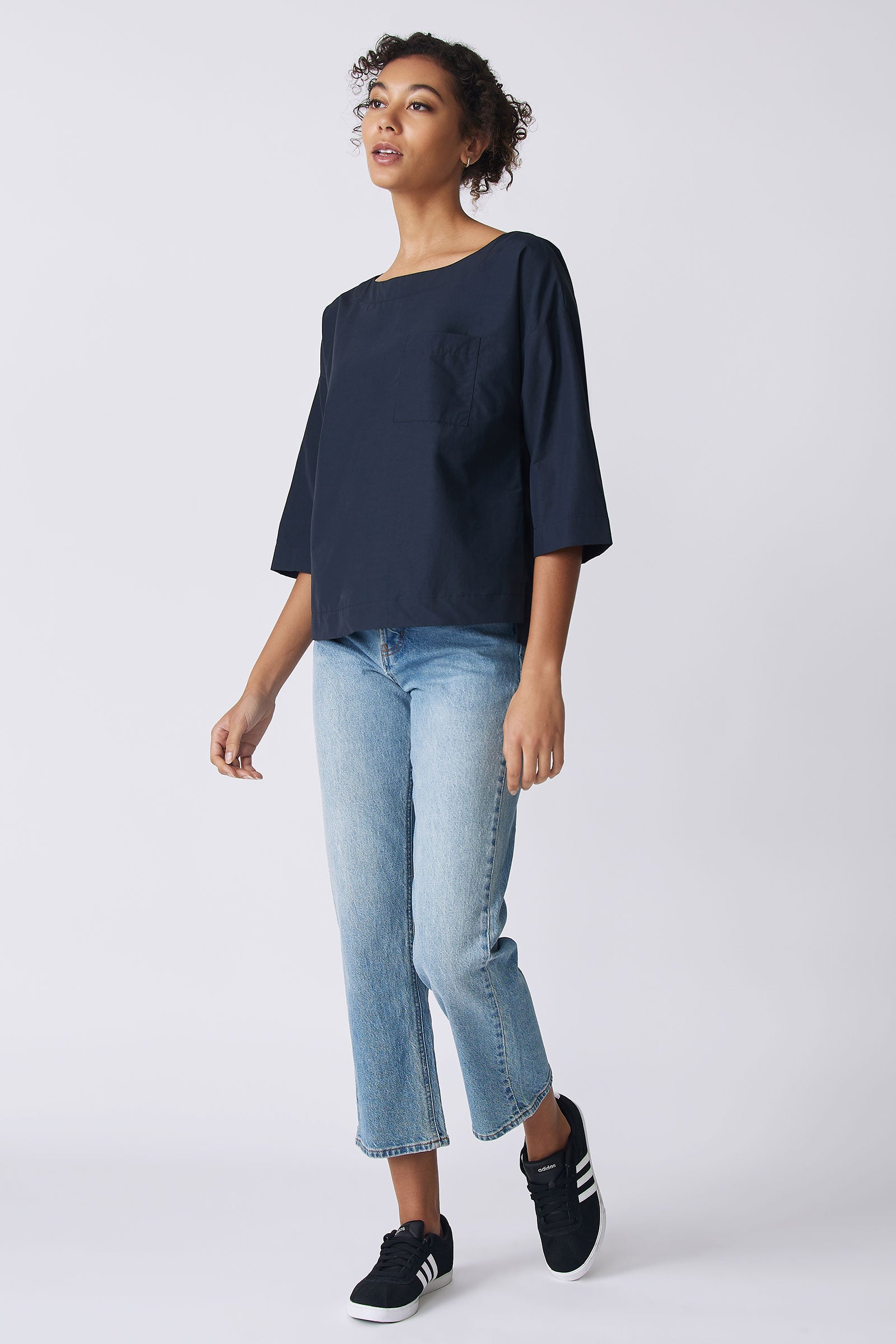 Kal Rieman Carmen Pocket Tee in Navy Broadcloth on model side view walking