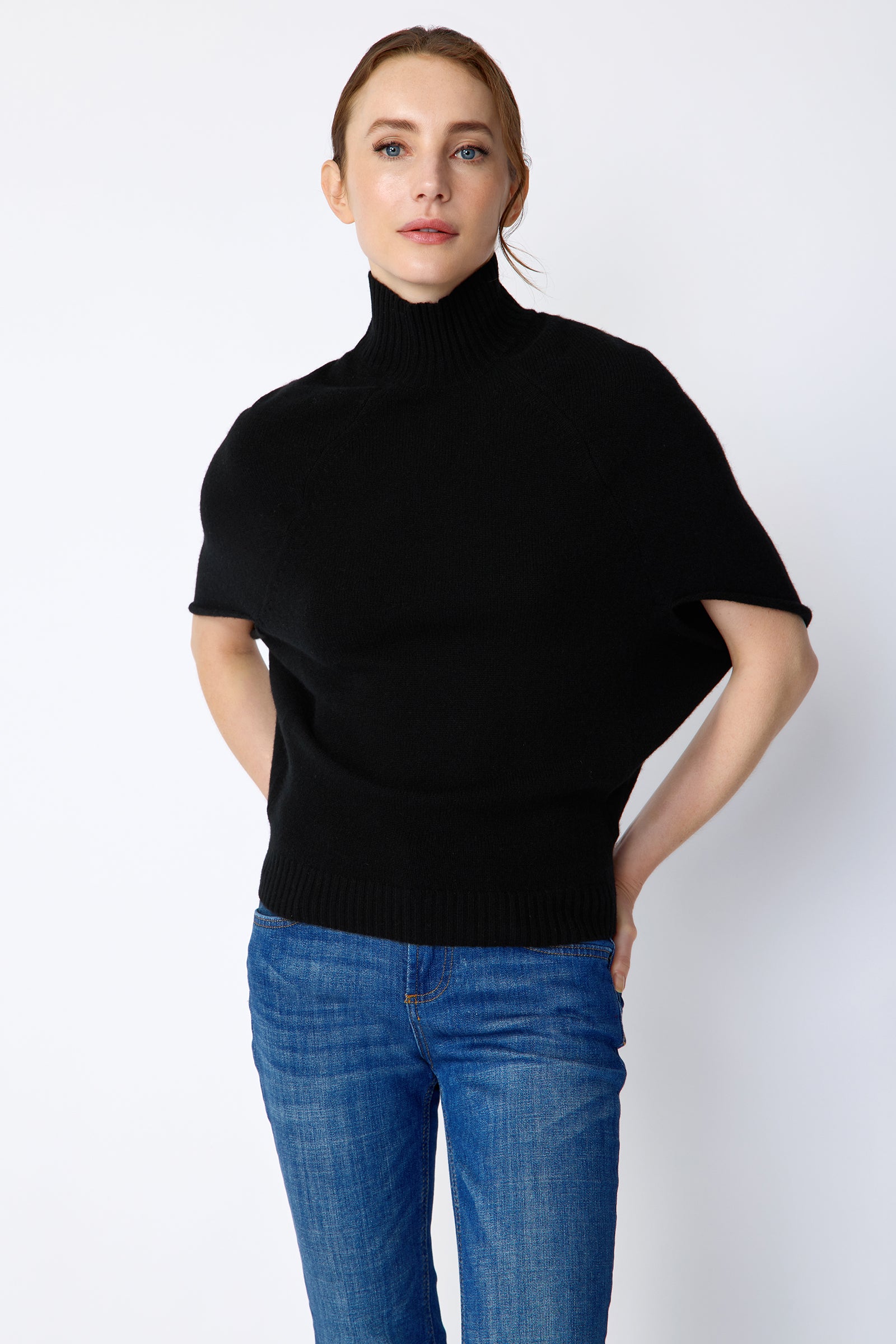 Kal Rieman Cashmere Cape Sweater in black on model front view hands in pockets
