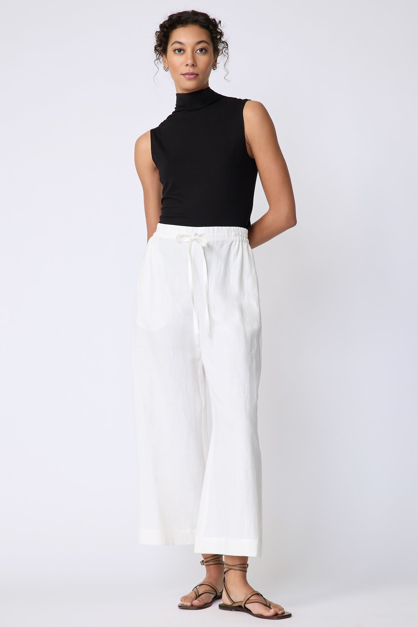 Kal Rieman Celeste Pant in Ecru Cotton linen on model front view standing hands behind back