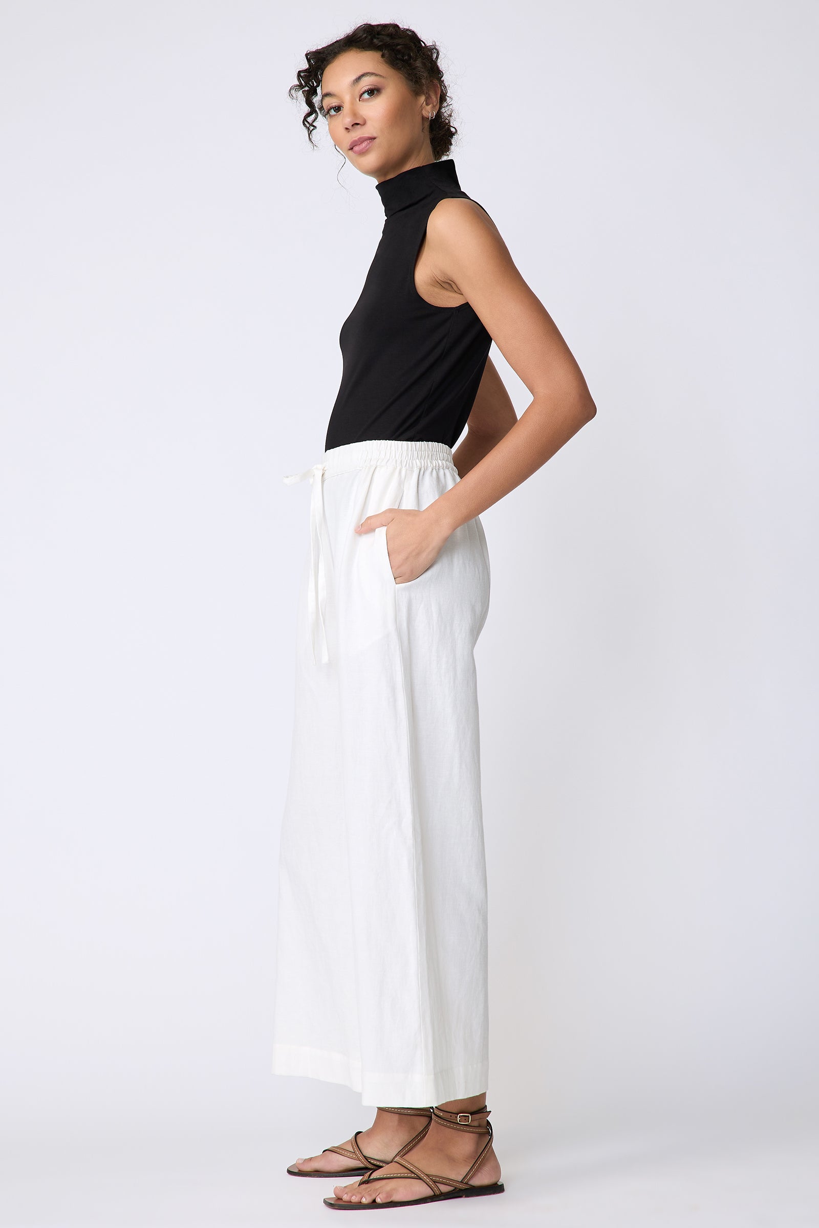 Kal Rieman Celeste Pant in Ecru Cotton linen on model side view hands in pocket