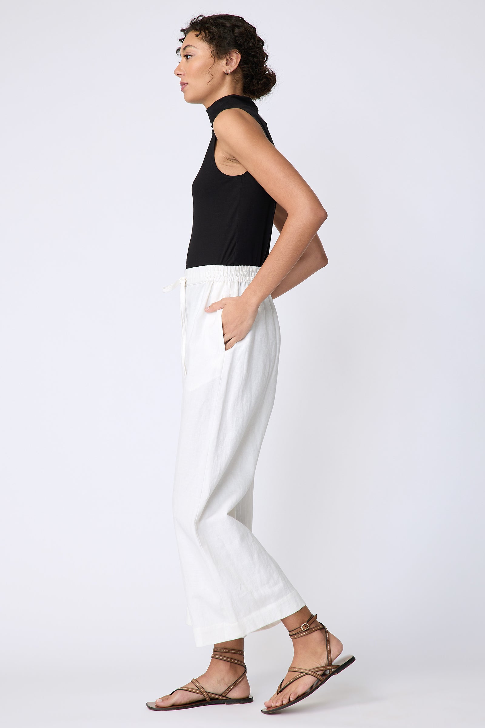 Kal Rieman Celeste Pant in Ecru Cotton linen on model side view walking