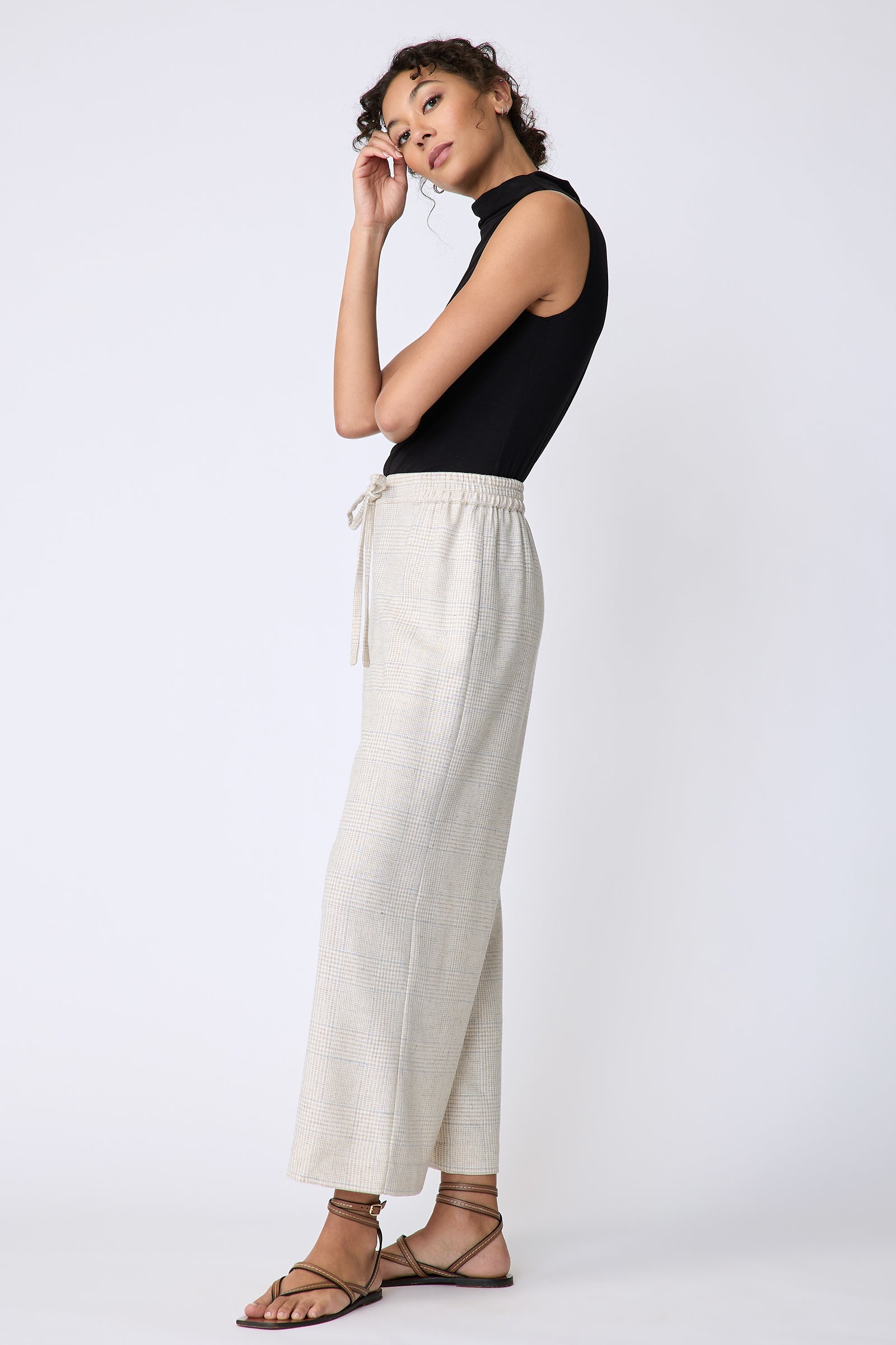 Kal Rieman Celeste Pant in Summer Plaid Suiting on model side view hands on face