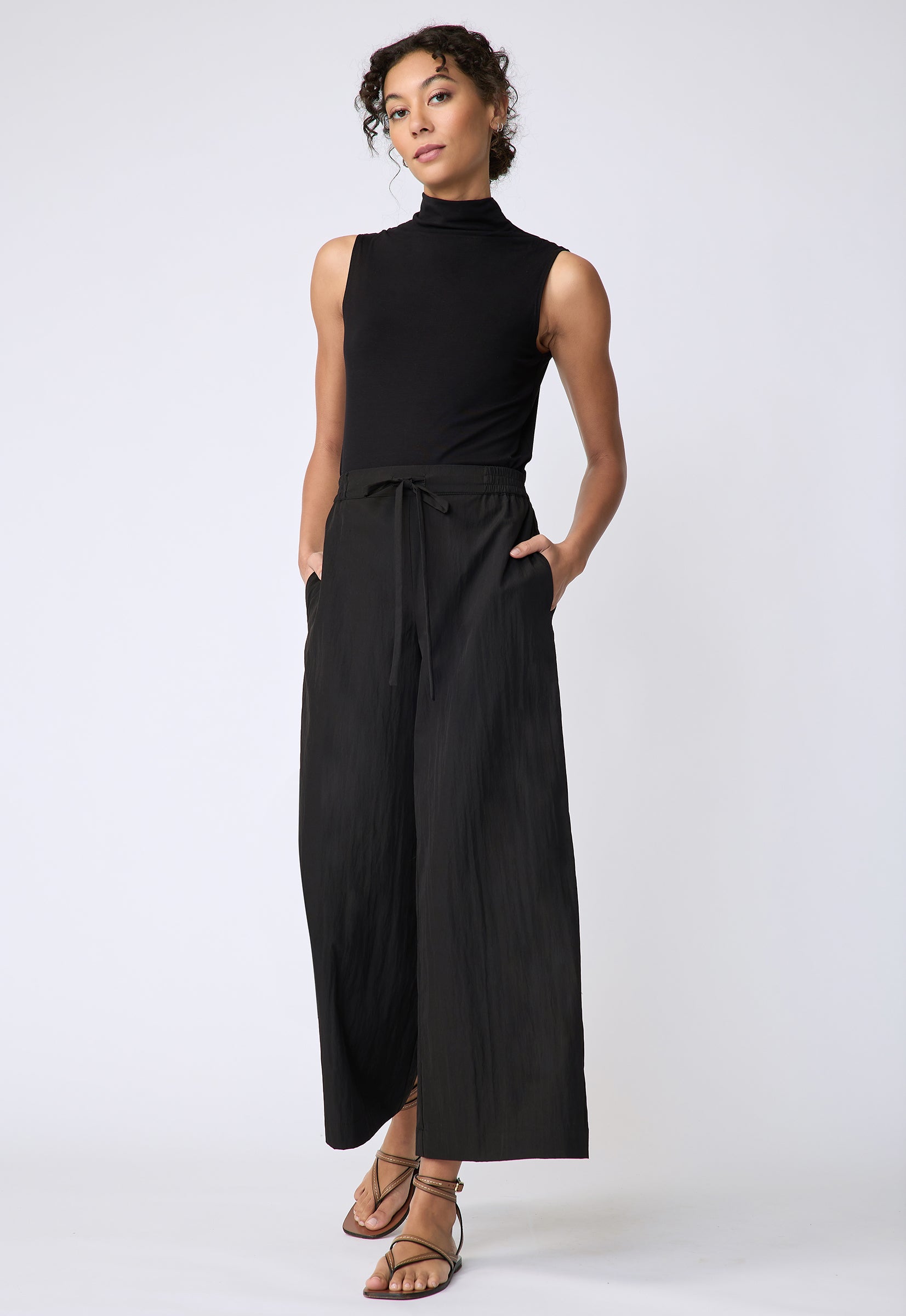 Kal Rieman Celeste Pant in black typewriter cloth on model front view hands in pockets