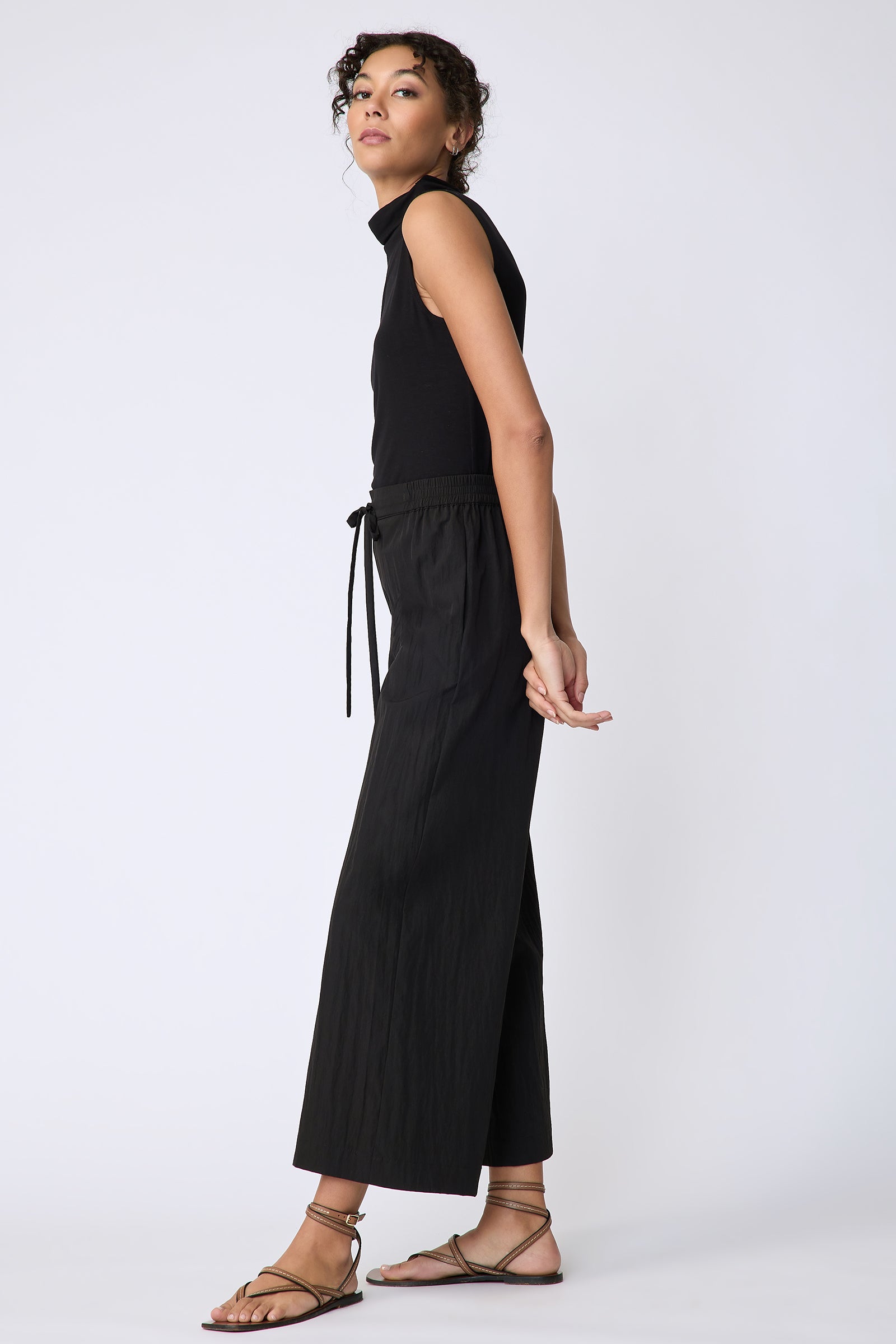 Kal Rieman Celeste Pant in black typewriter cloth on model side view hands behind back