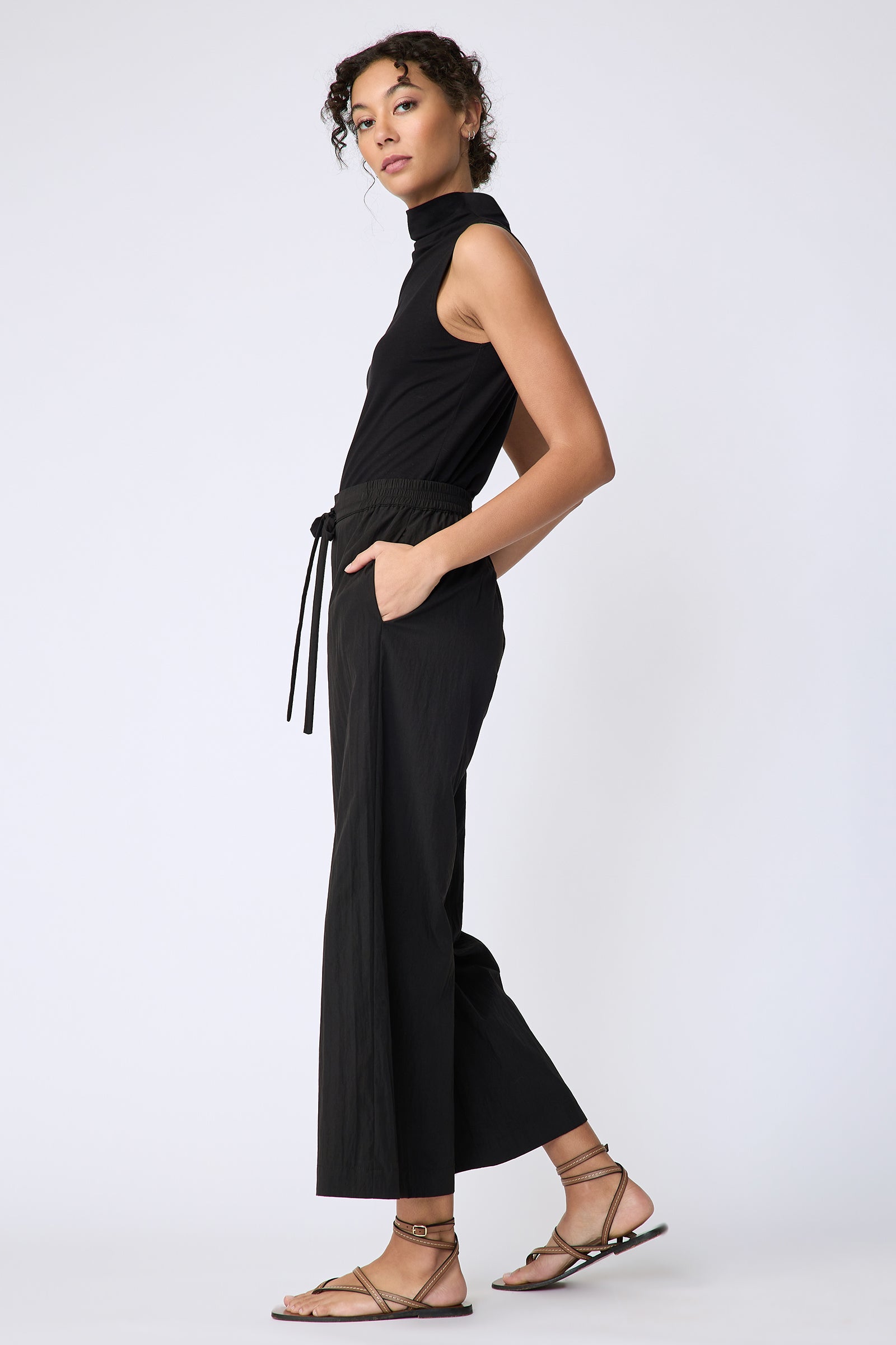 Kal Rieman Celeste Pant in black typewriter cloth on model side view hands in pockets