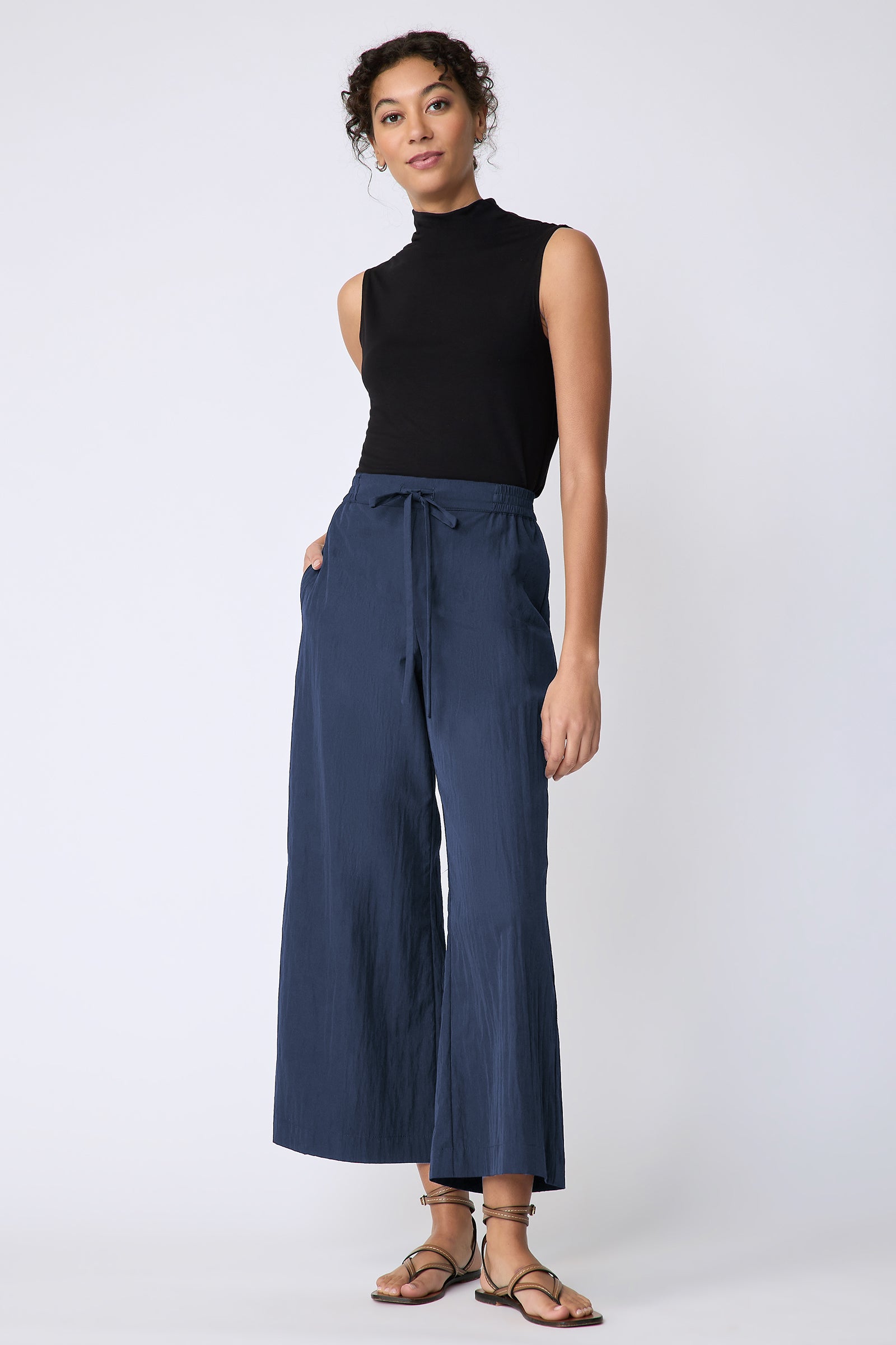 Kal Rieman Celeste Pant in navy typewriter cloth on model hand in pocket