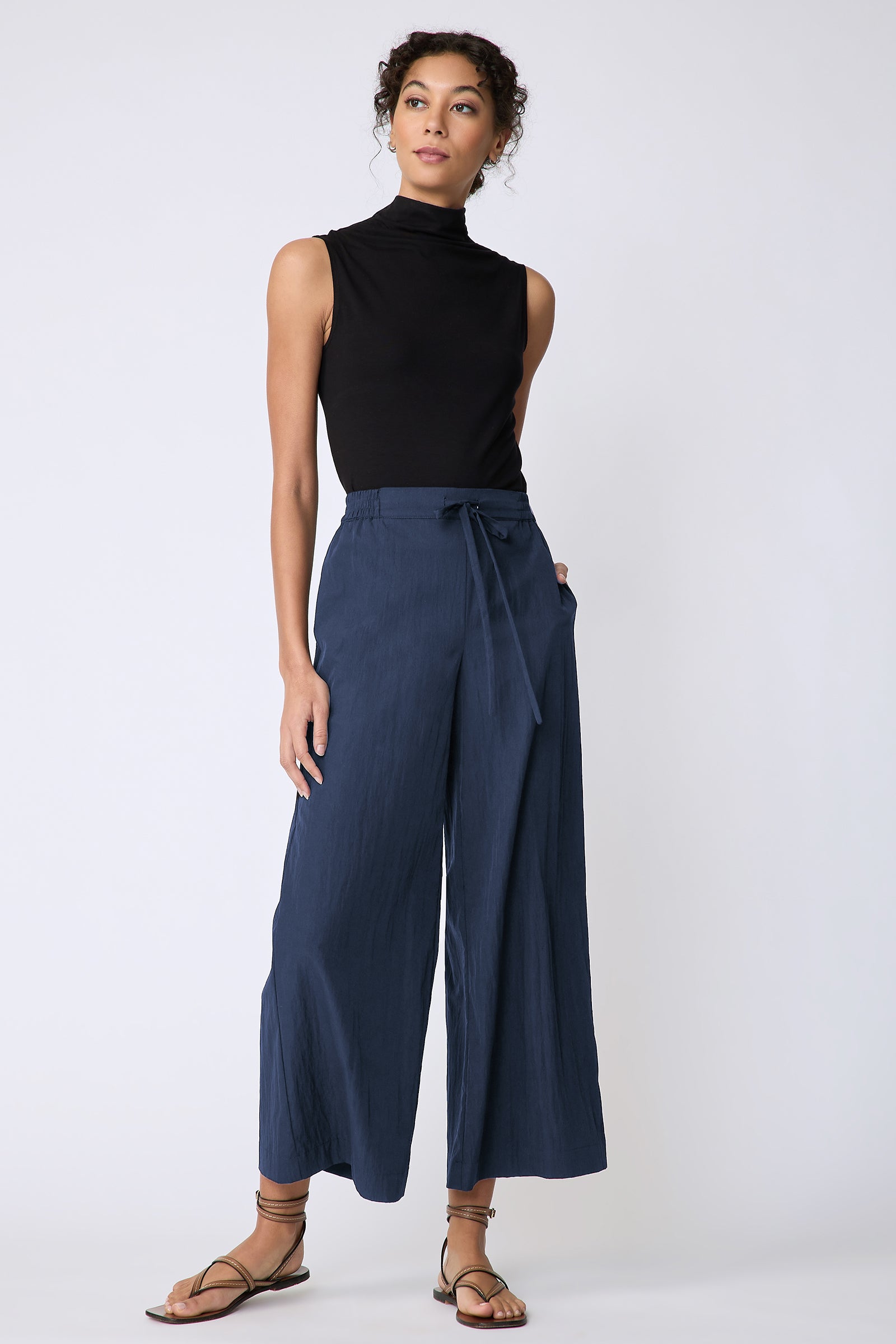 Kal Rieman Celeste Pant in navy typewriter cloth on model hand in pocket