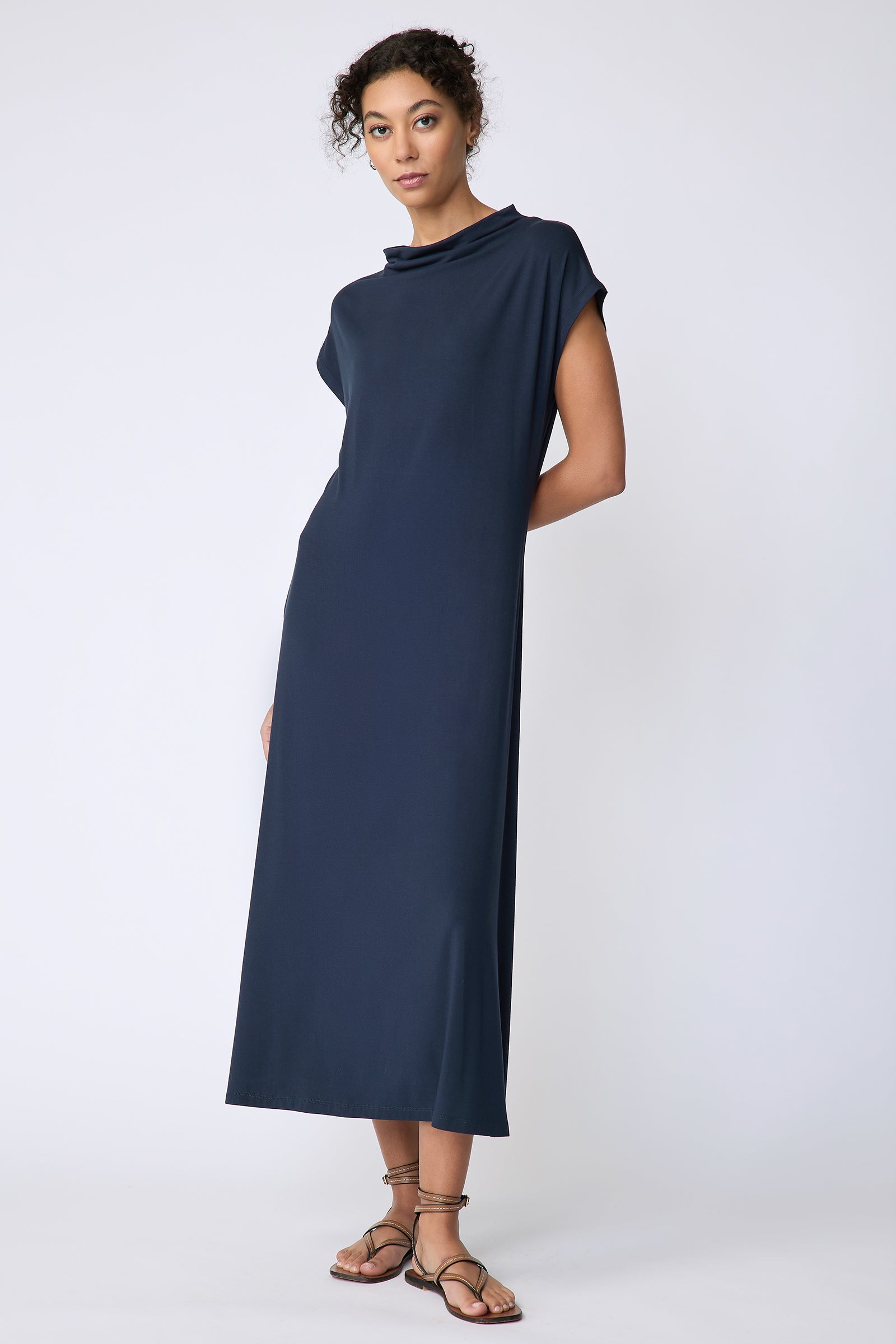 Kal Rieman Christie Knit dress in navy bamboo jersey on model front view hands behind back