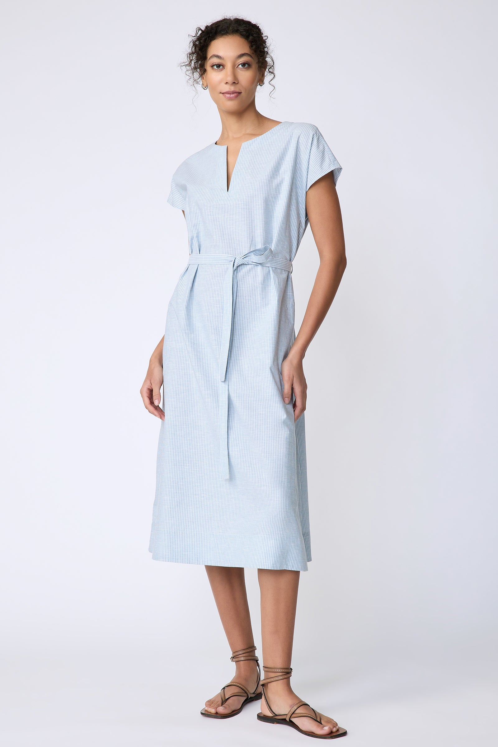 Kal Rieman Clara Dress in light blue mini stripe on model front view hands on hips