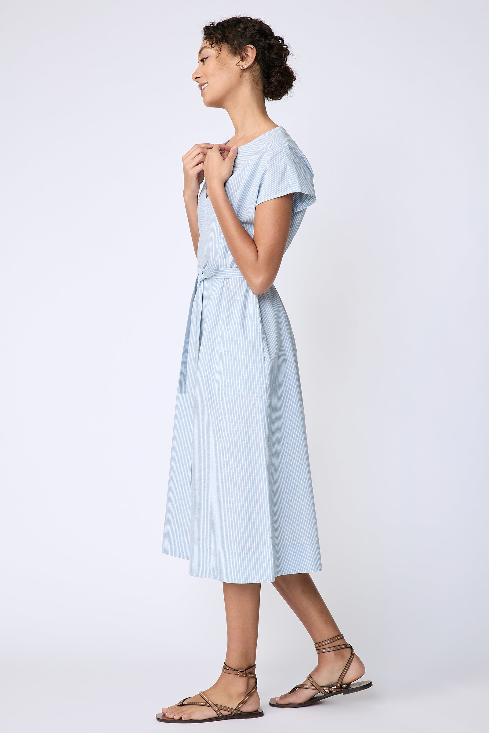 Kal Rieman Clara Dress in light blue mini stripe on model side view holding collar