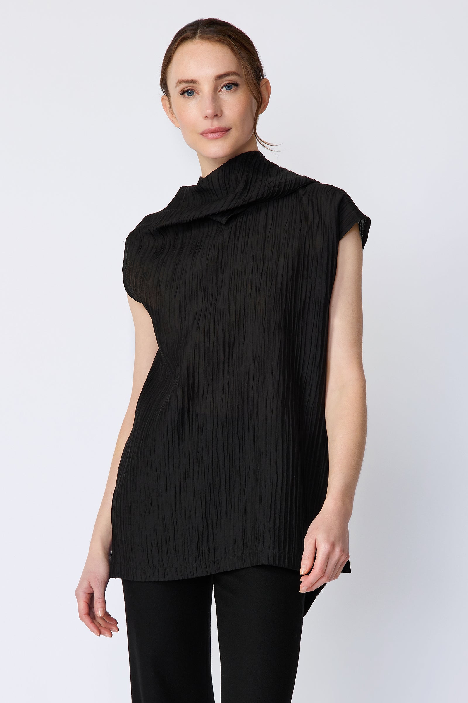 Woman wearing Kal Rieman Claudia Scarf Tunic in Black Taffeta on a white background, arms on the side, close view