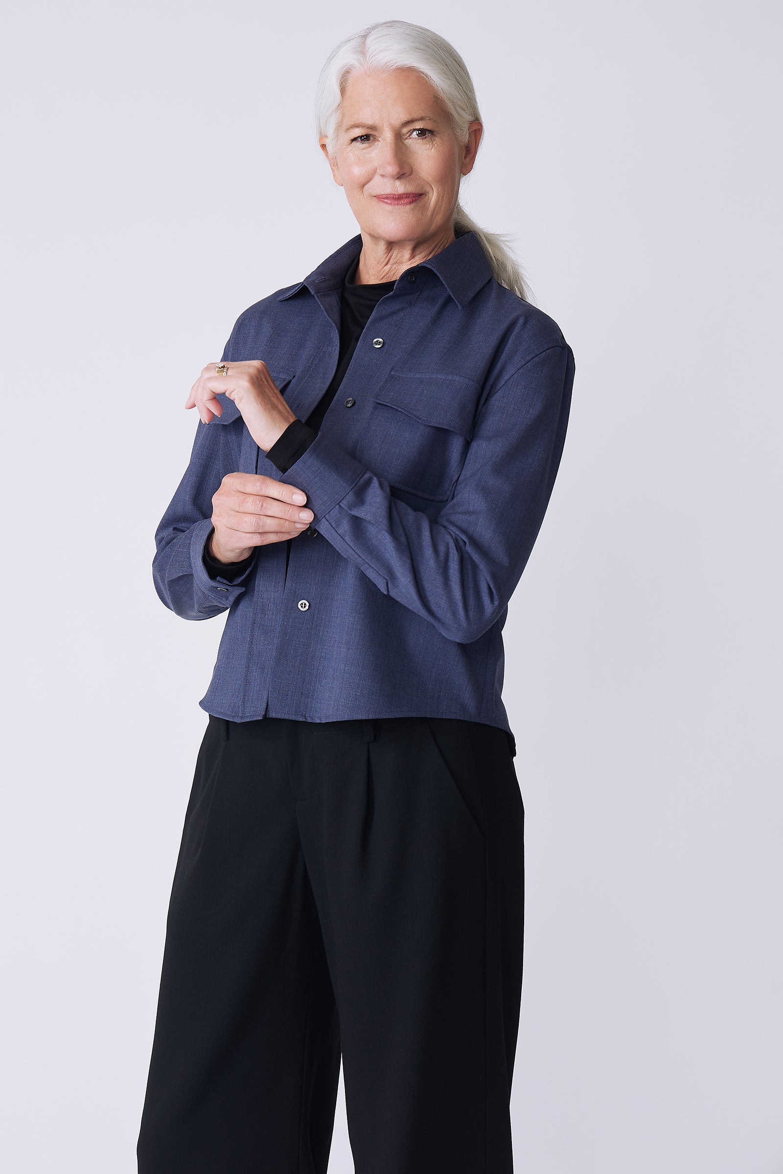Kal Rieman Crop Tailored Shirt in denim suiting on model side view holding cuff