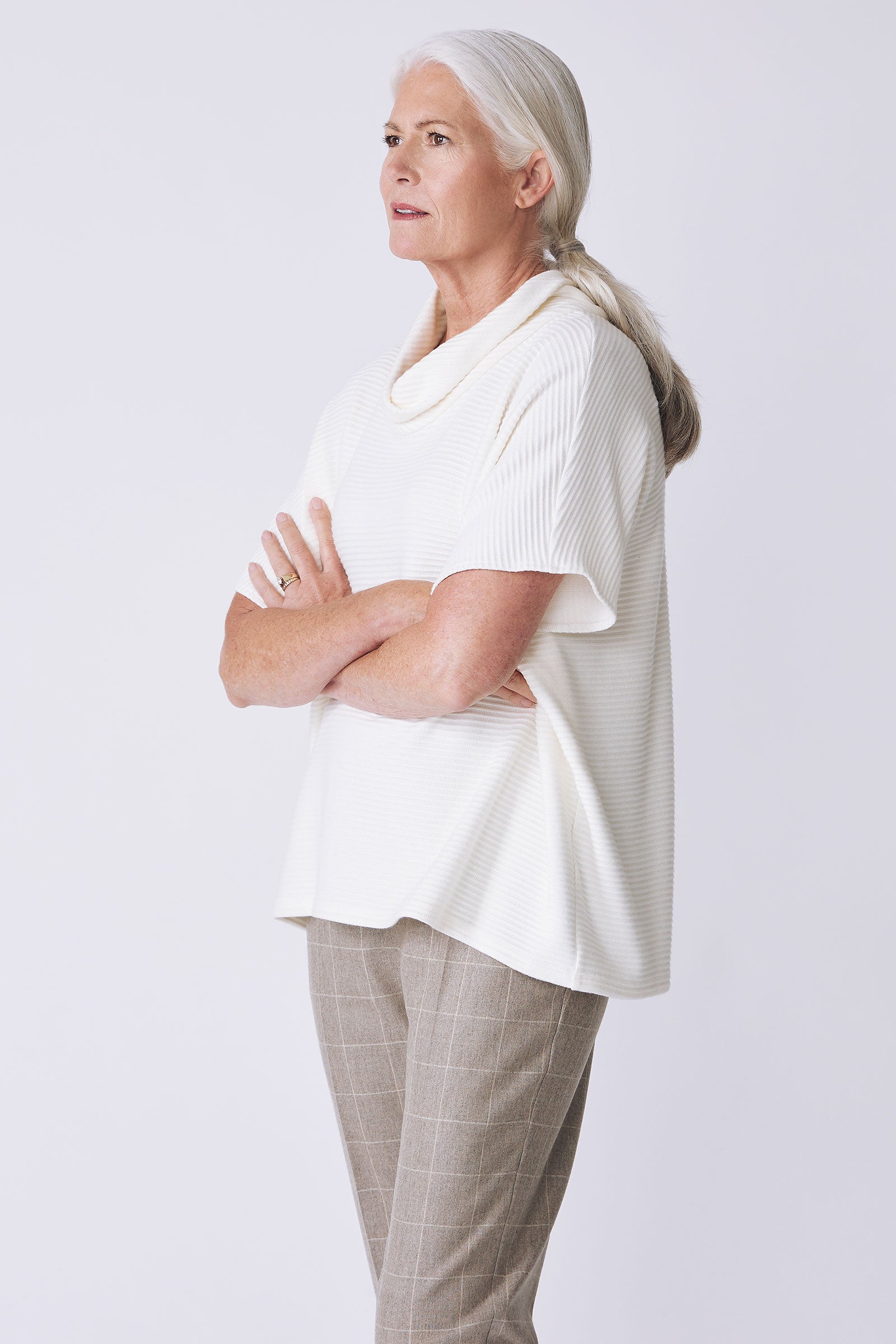 Kal Rieman Dafne Cowl Rib Tneck in ivory on model side view arms crossed