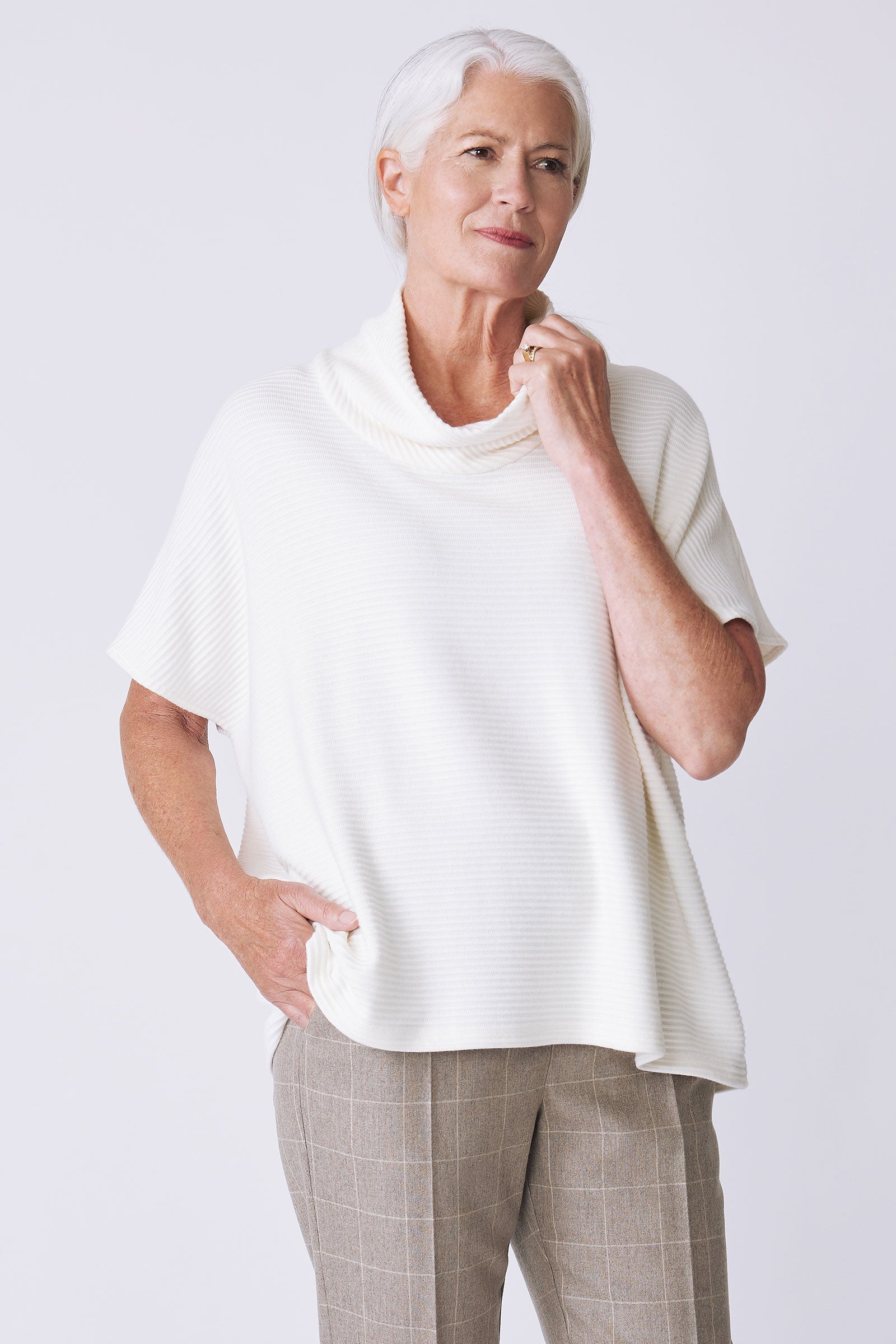 Kal Rieman Dafne Cowl Rib Tneck in ivory on model side view holding collar