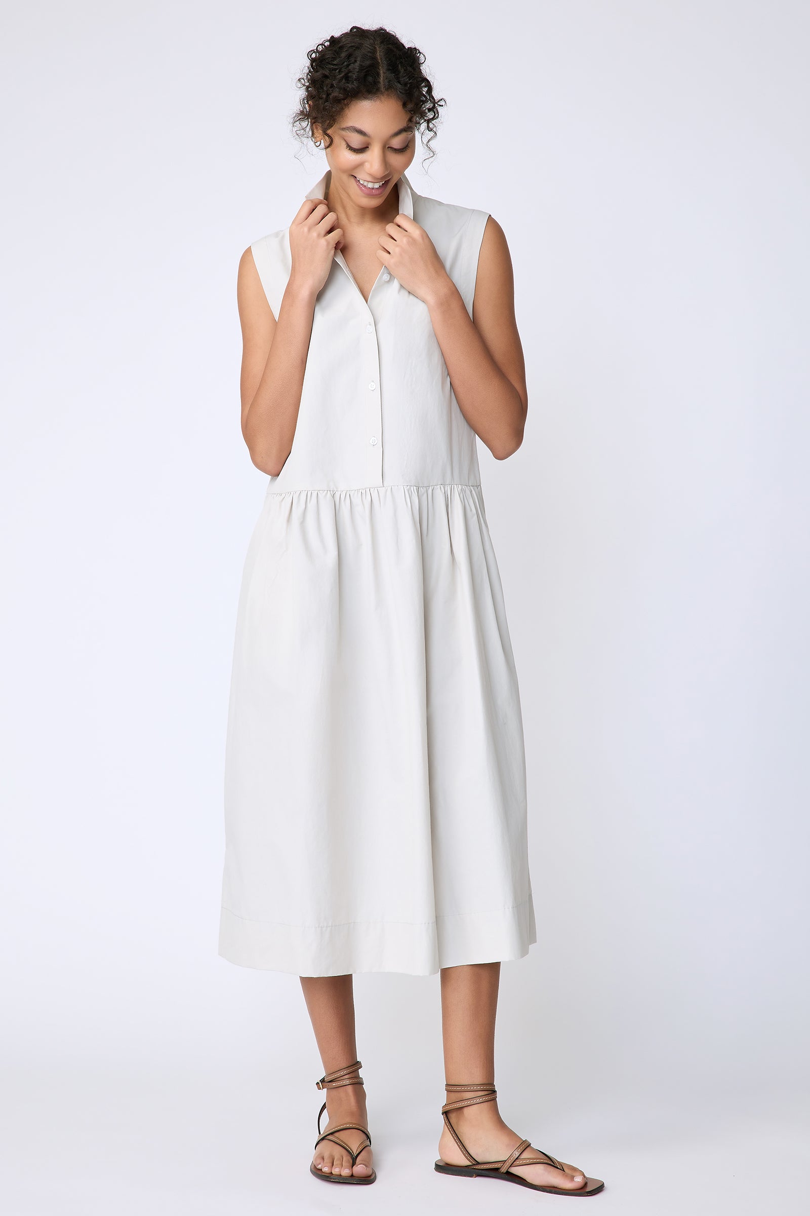 Kal Rieman Demi Dress in Italian Broadcloth stone color on model front view holding collar
