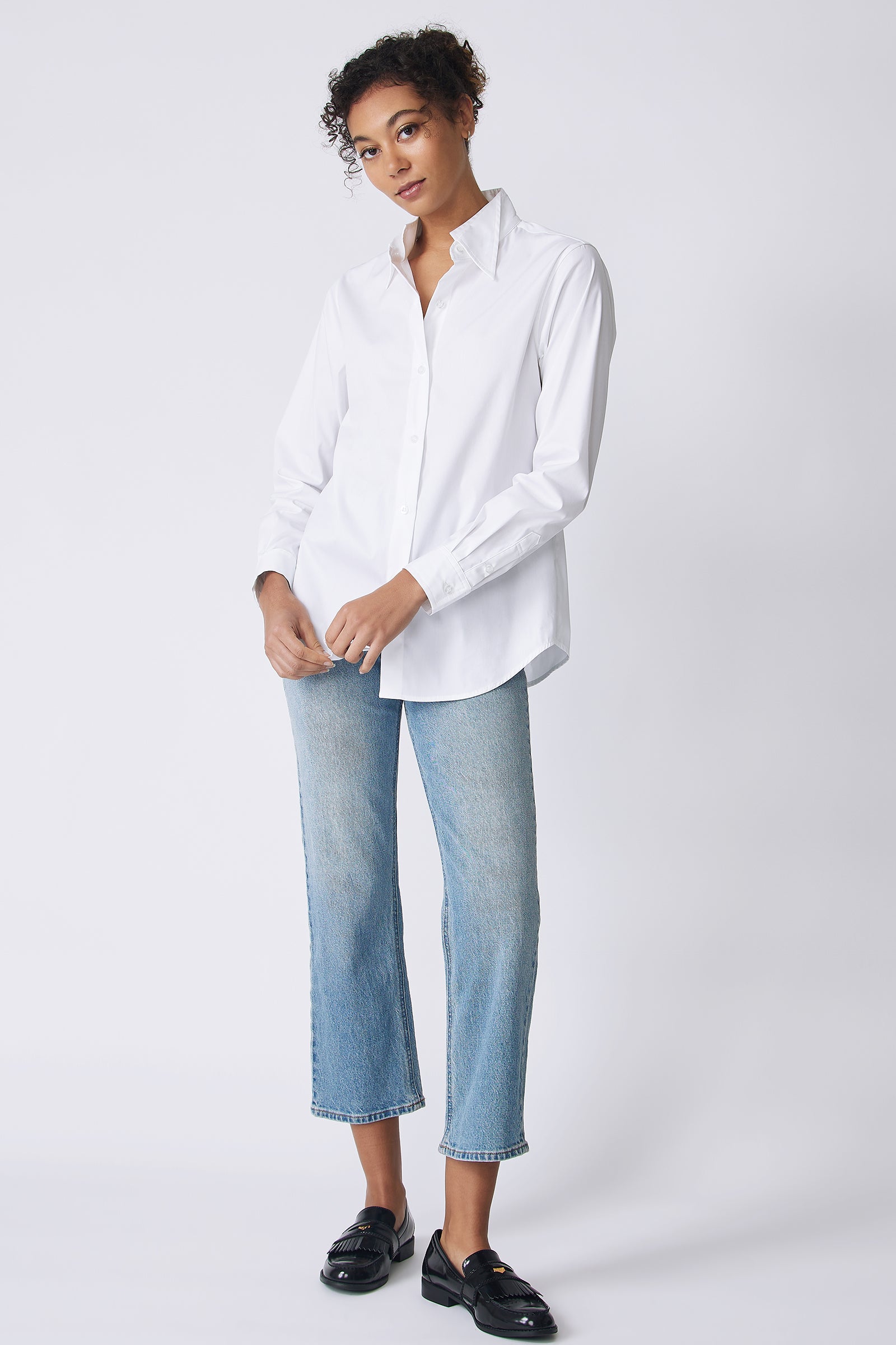 Kal Rieman Double Collar Shirt in white stretch poplin on model front view holding hem