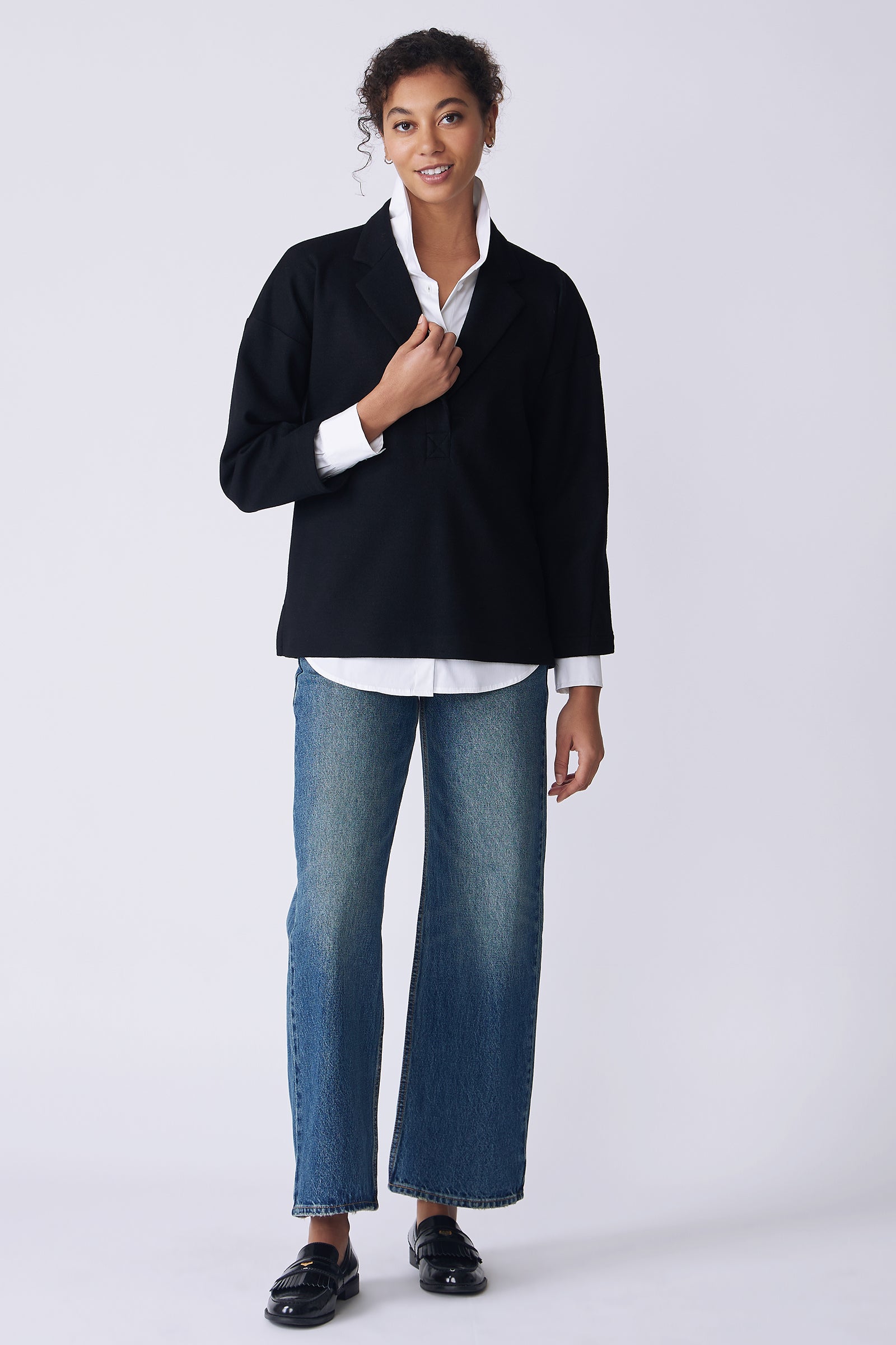 Kal Rieman Elaine Notch Placket Pullover in black Italian felted jersey on model front view holding collar
