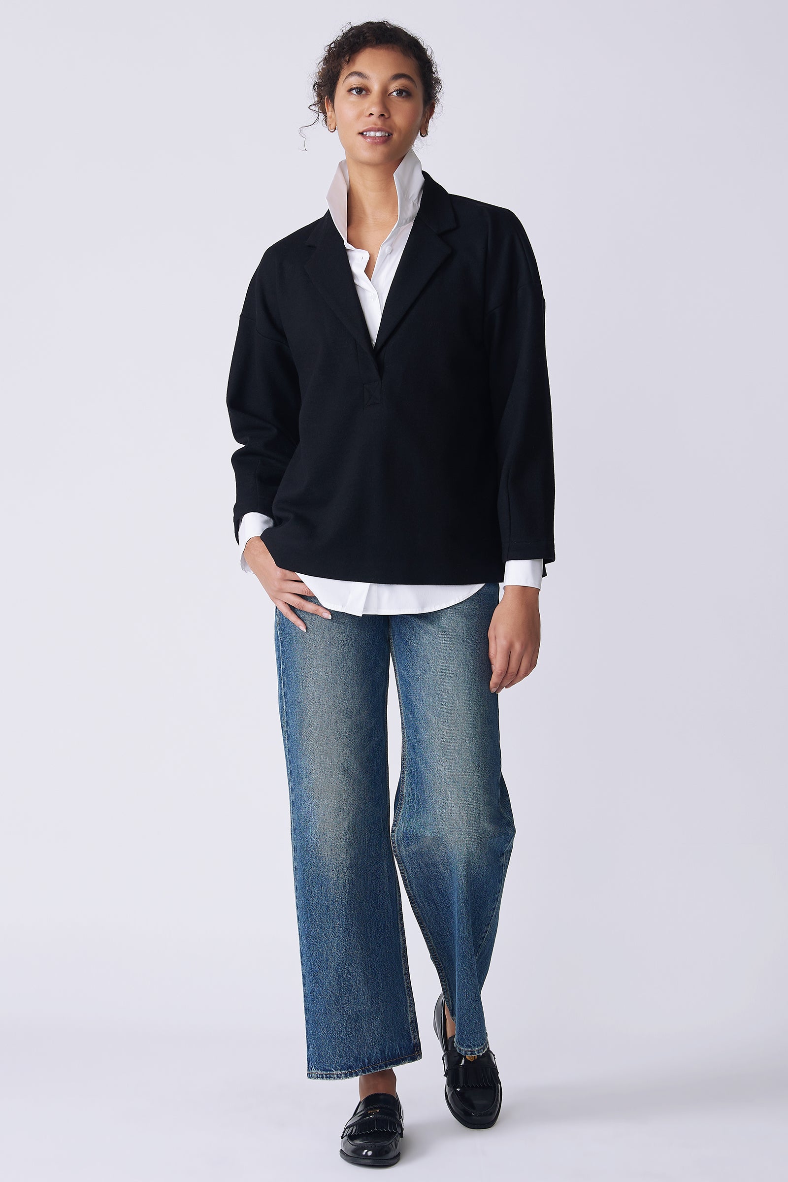 Kal Rieman Elaine Notch Placket Pullover in black Italian felted jersey on model front view walking