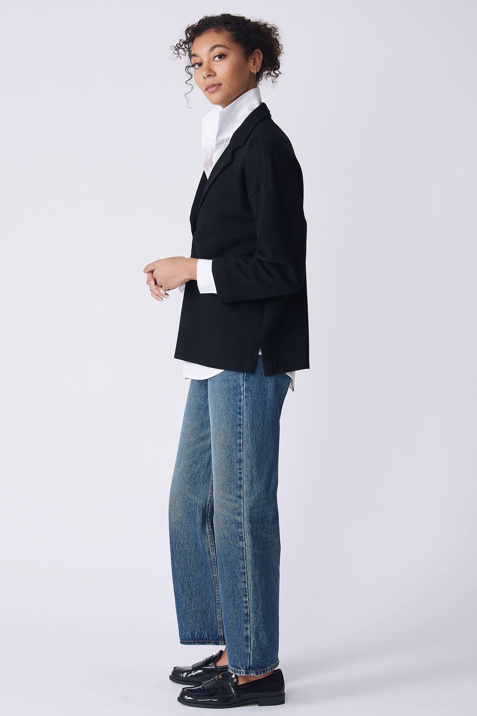 Kal Rieman Elaine Notch Placket Pullover in black Italian felted jersey on model side view looking at camera