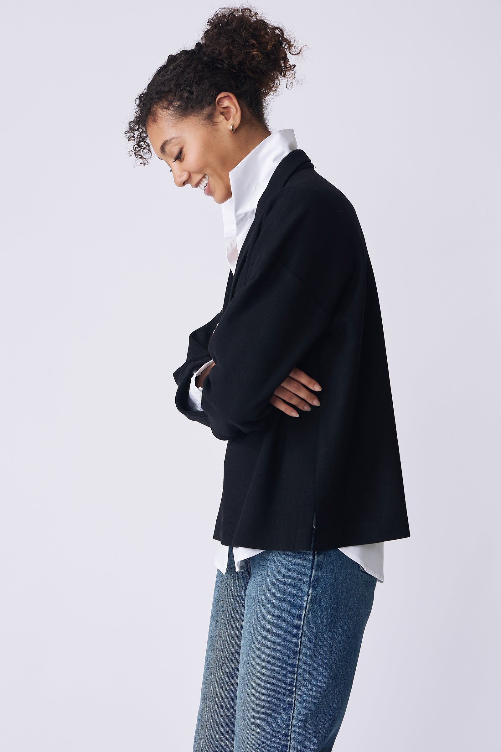 Kal Rieman Elaine Notch Placket Pullover in black Italian felted jersey on model side view looking down arms crossed
