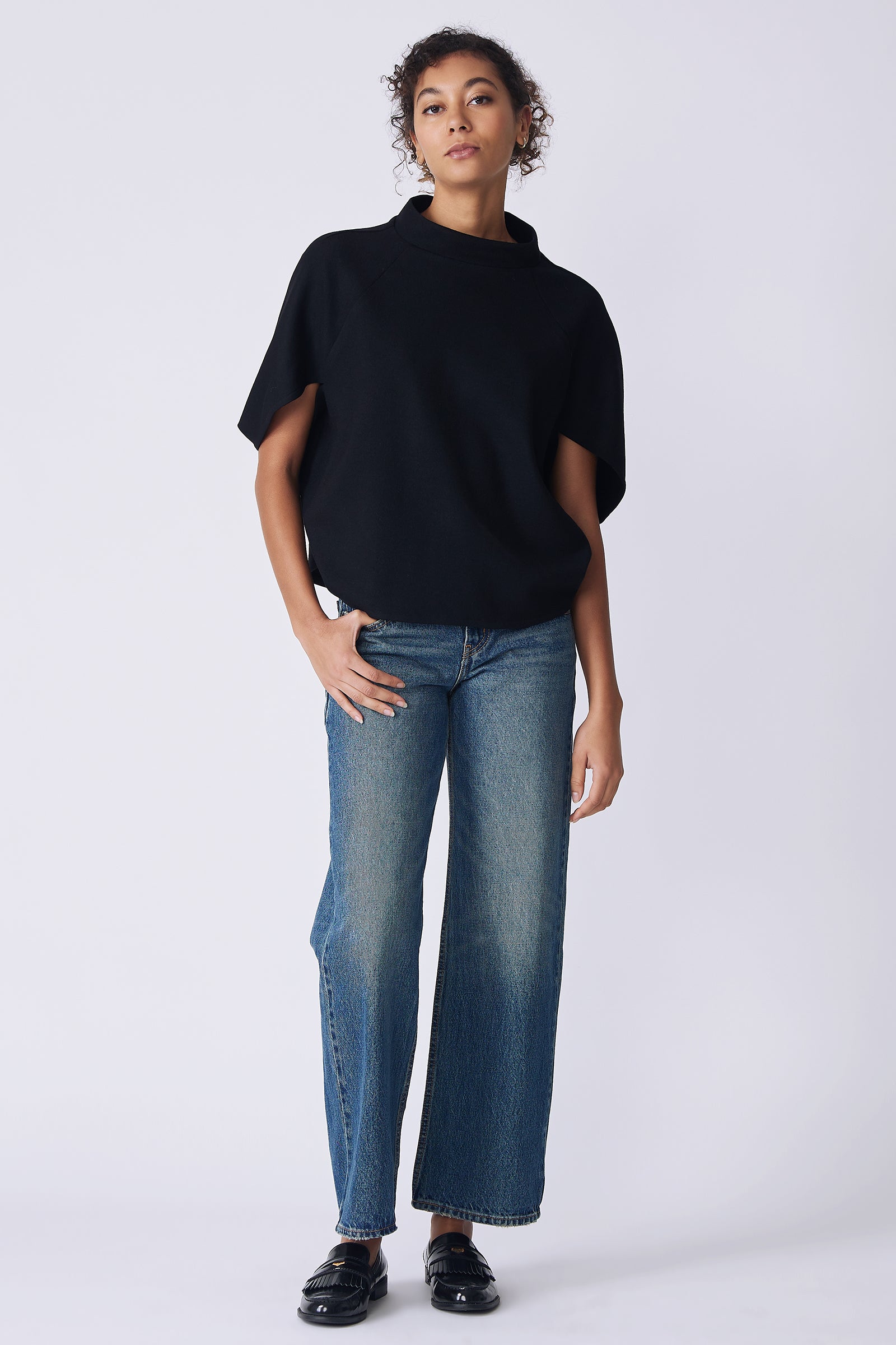 Kal Rieman Elsa Cape Top in black on model front view hand in pocket