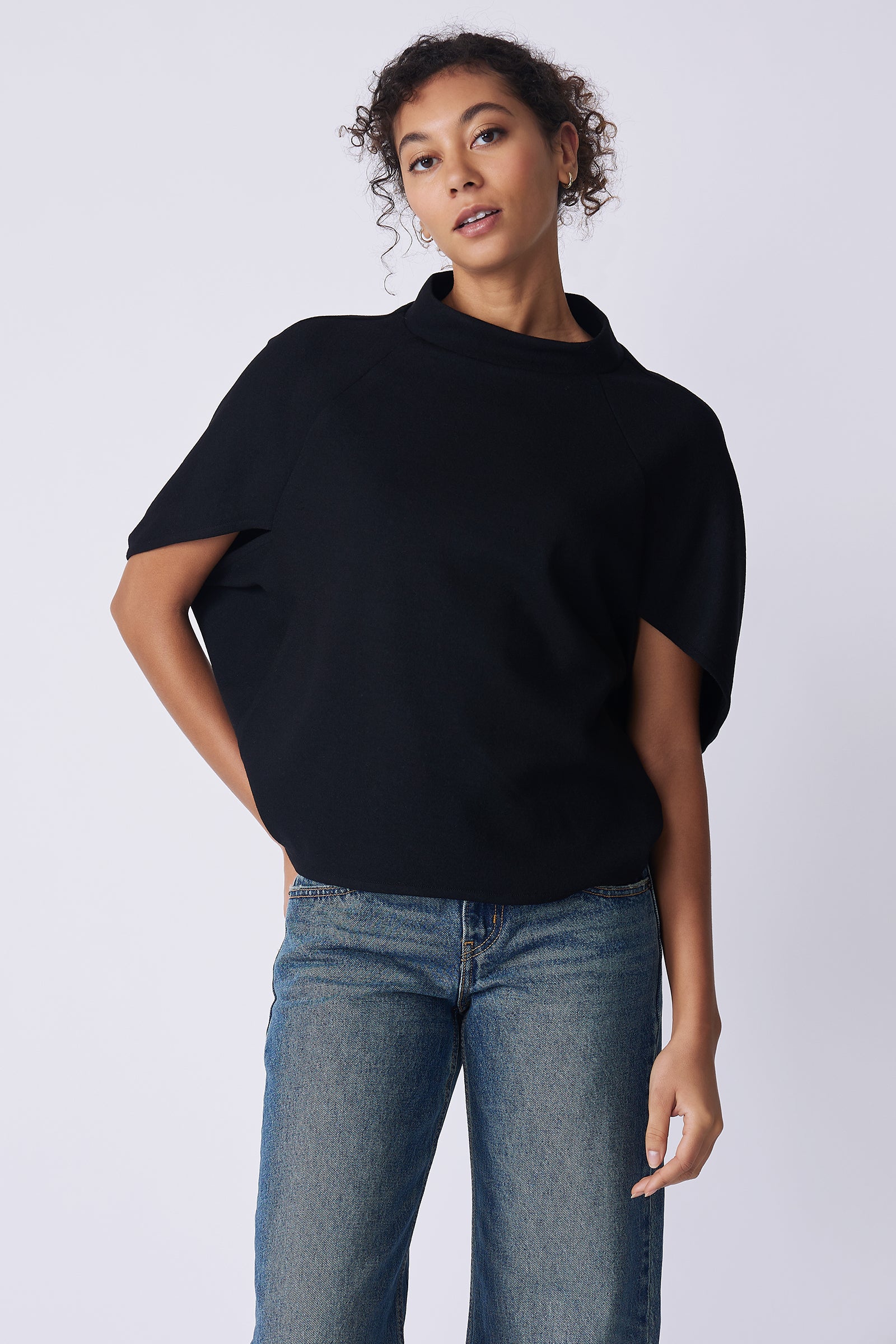 Kal Rieman Elsa Cape Top in black on model front view hand on hip