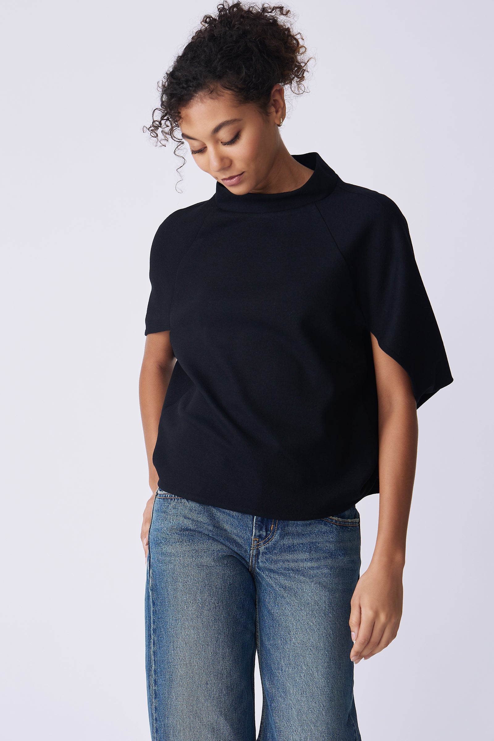 Kal Rieman Elsa Cape Top in black on model front view walking looking down