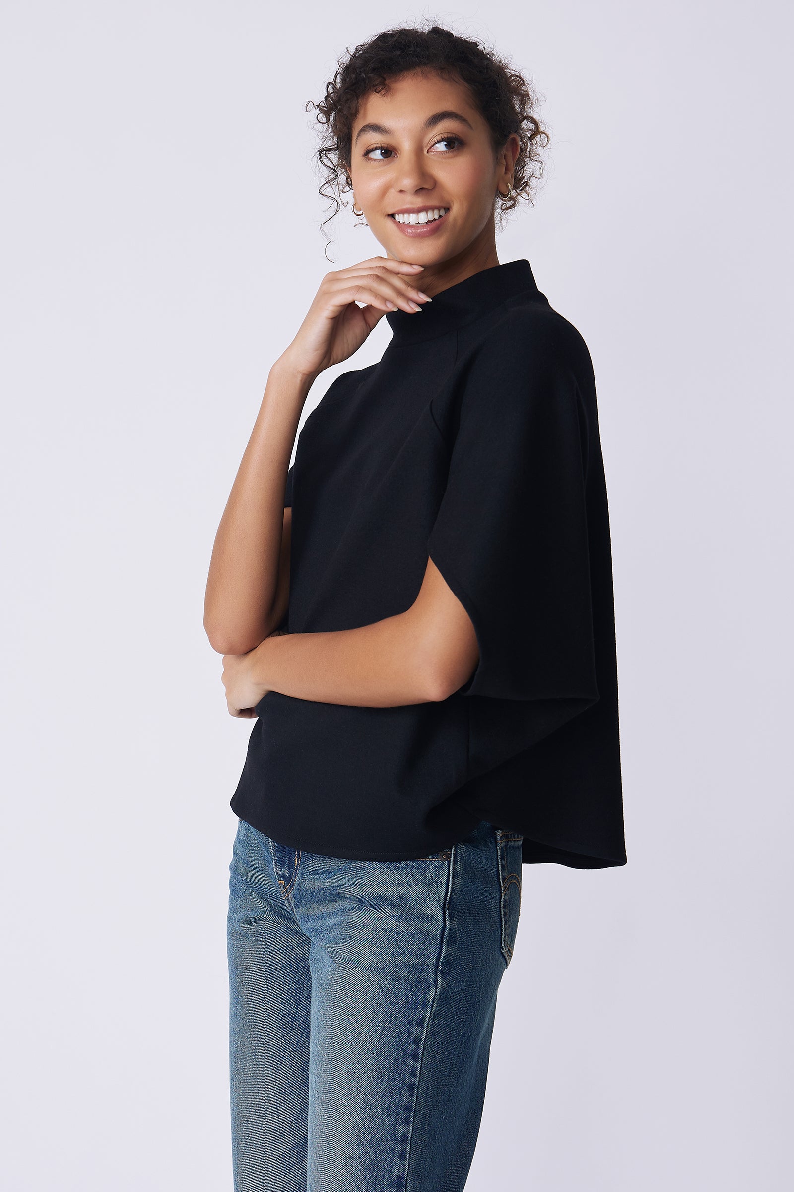 Kal Rieman Elsa Cape Top in black on model side view hand on chin