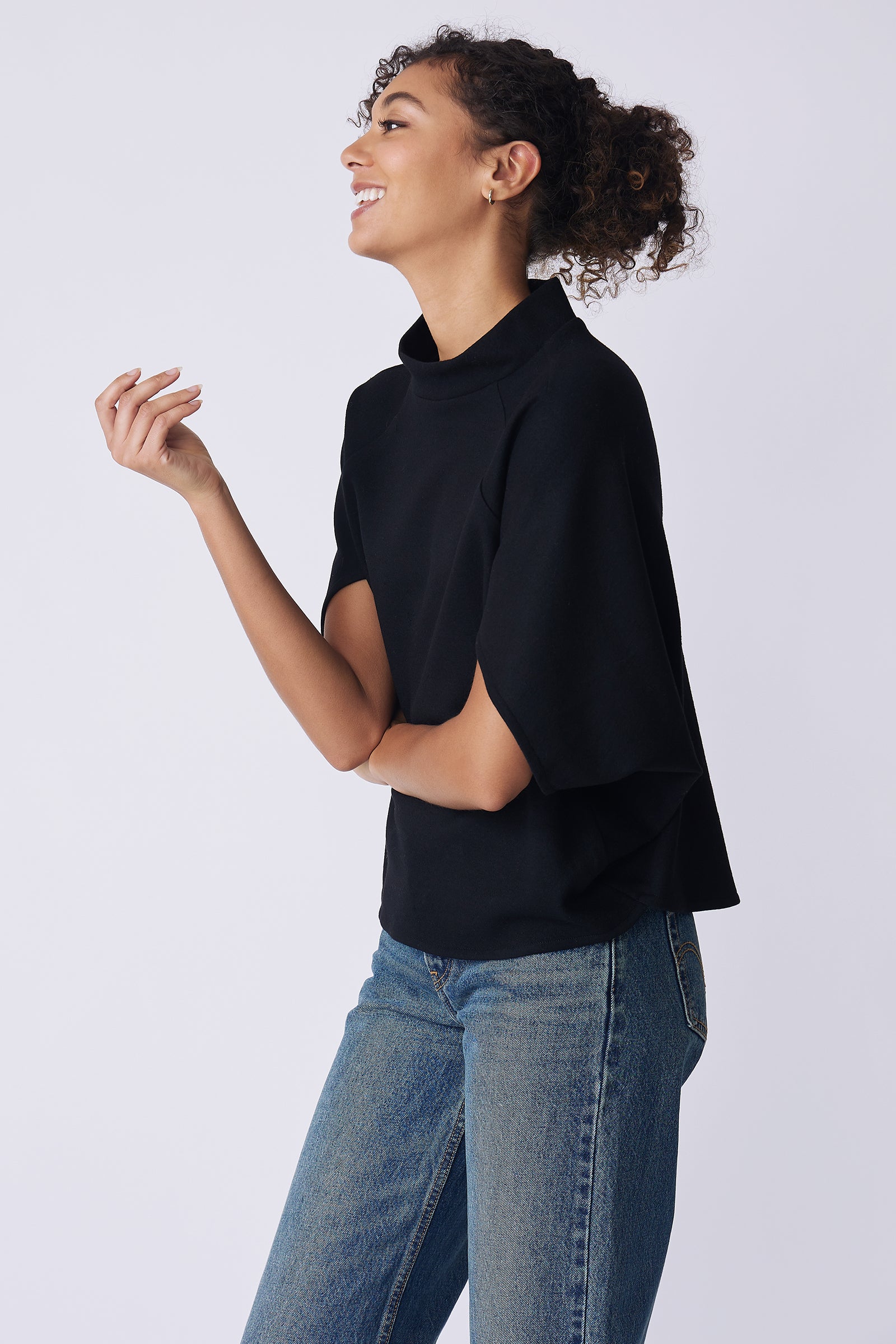 Kal Rieman Elsa Cape Top in black on model side view laughing