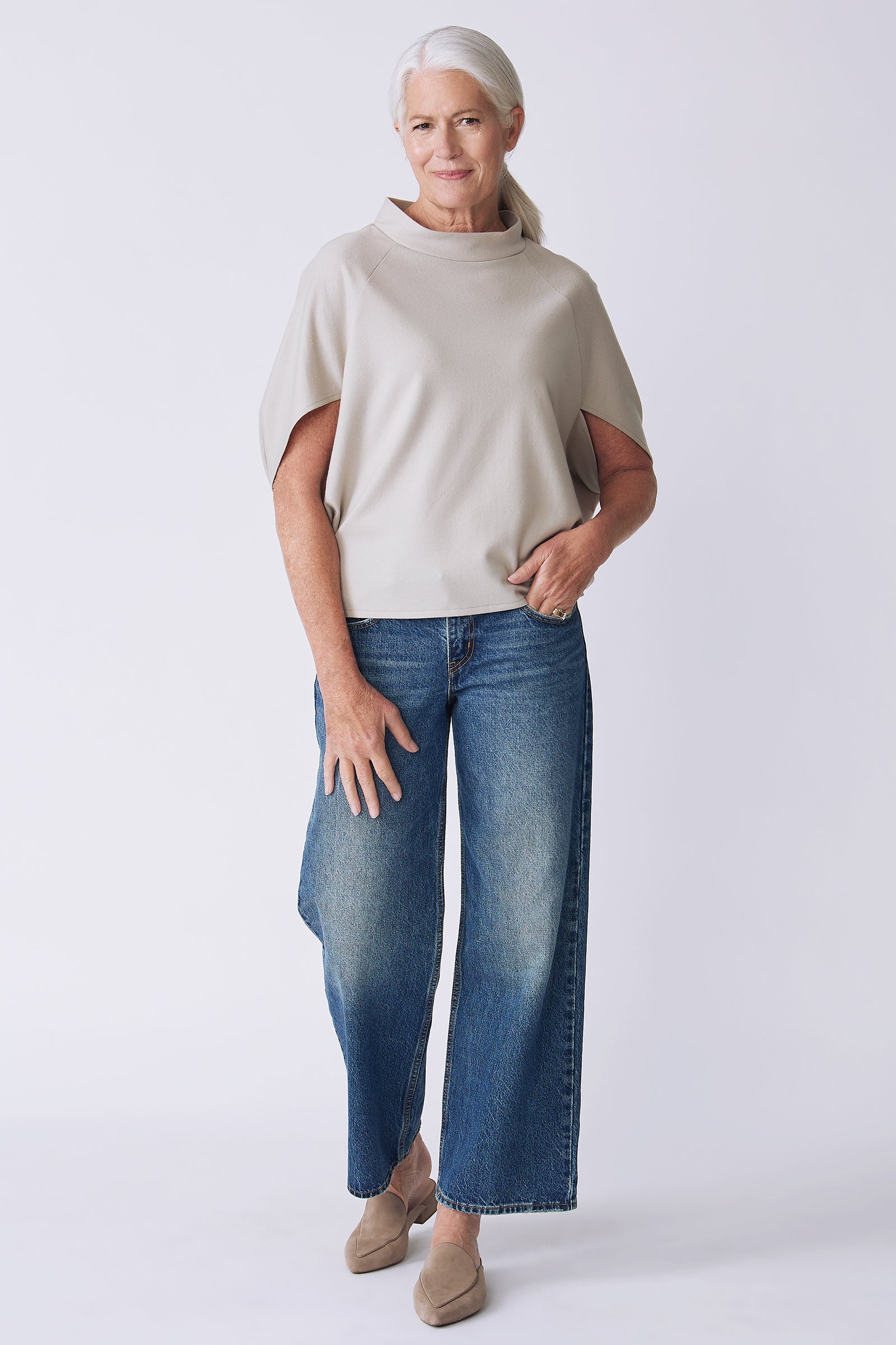Kal Rieman Elsa Cape Top in mink felted jersey on model side view hands in pocket walking