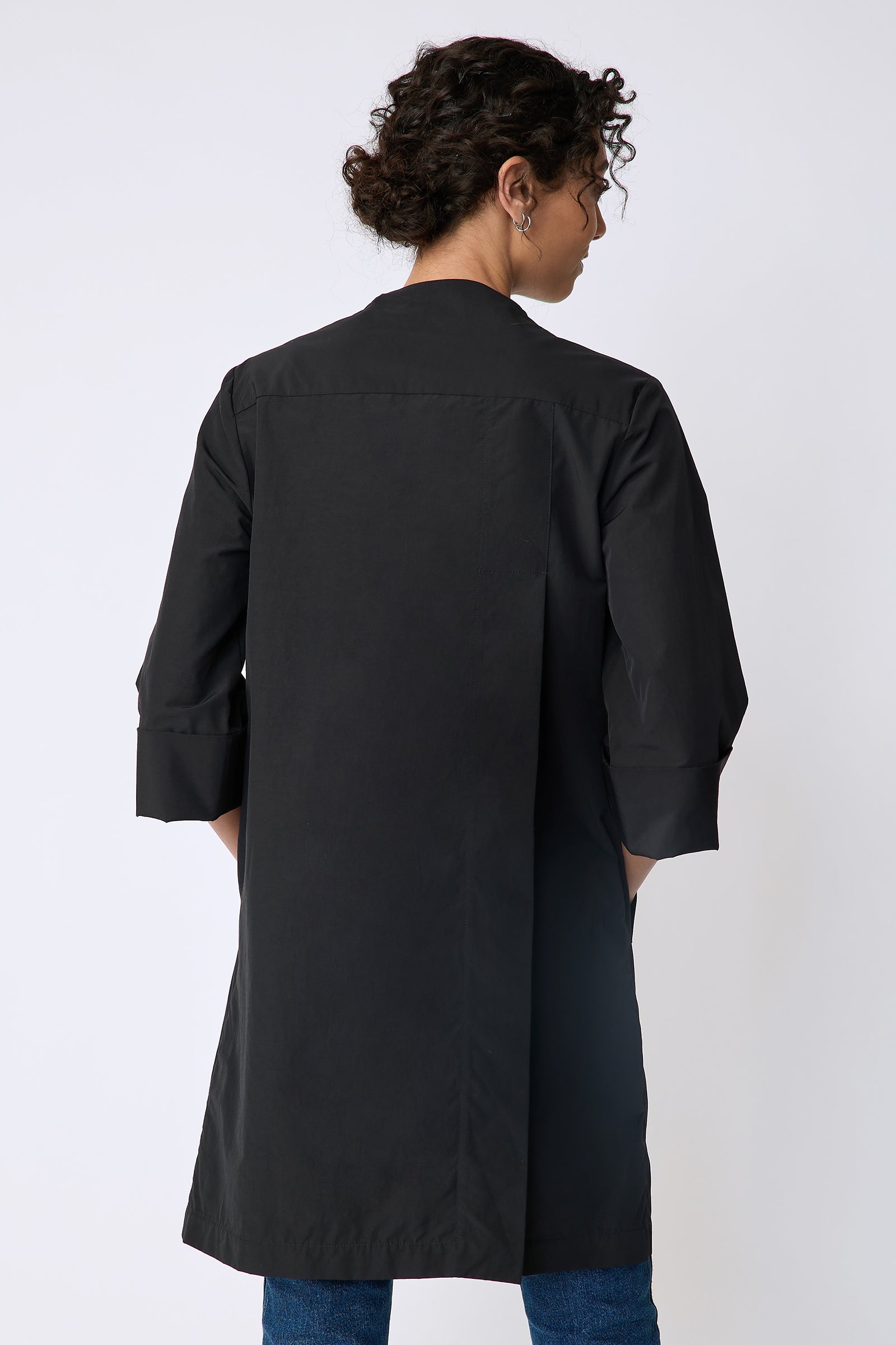 Kal Rieman Else Peacoat in Italian Broadcloth black on model front view holding front of jacket