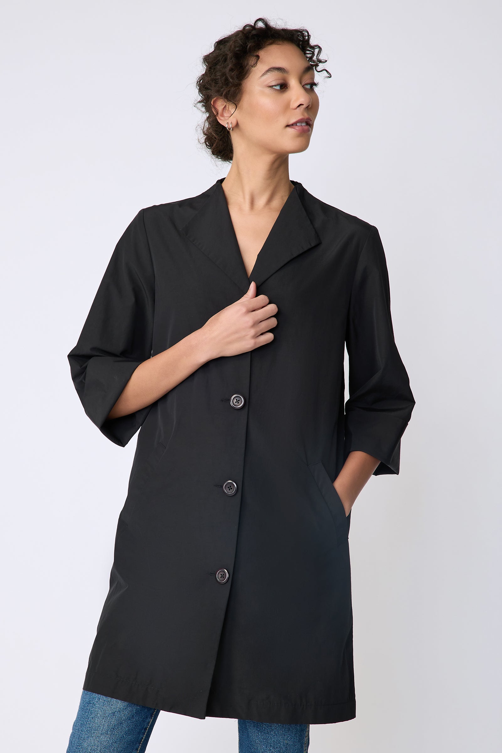 Kal Rieman Else Peacoat in Italian Broadcloth black on model front view holding front of jacket